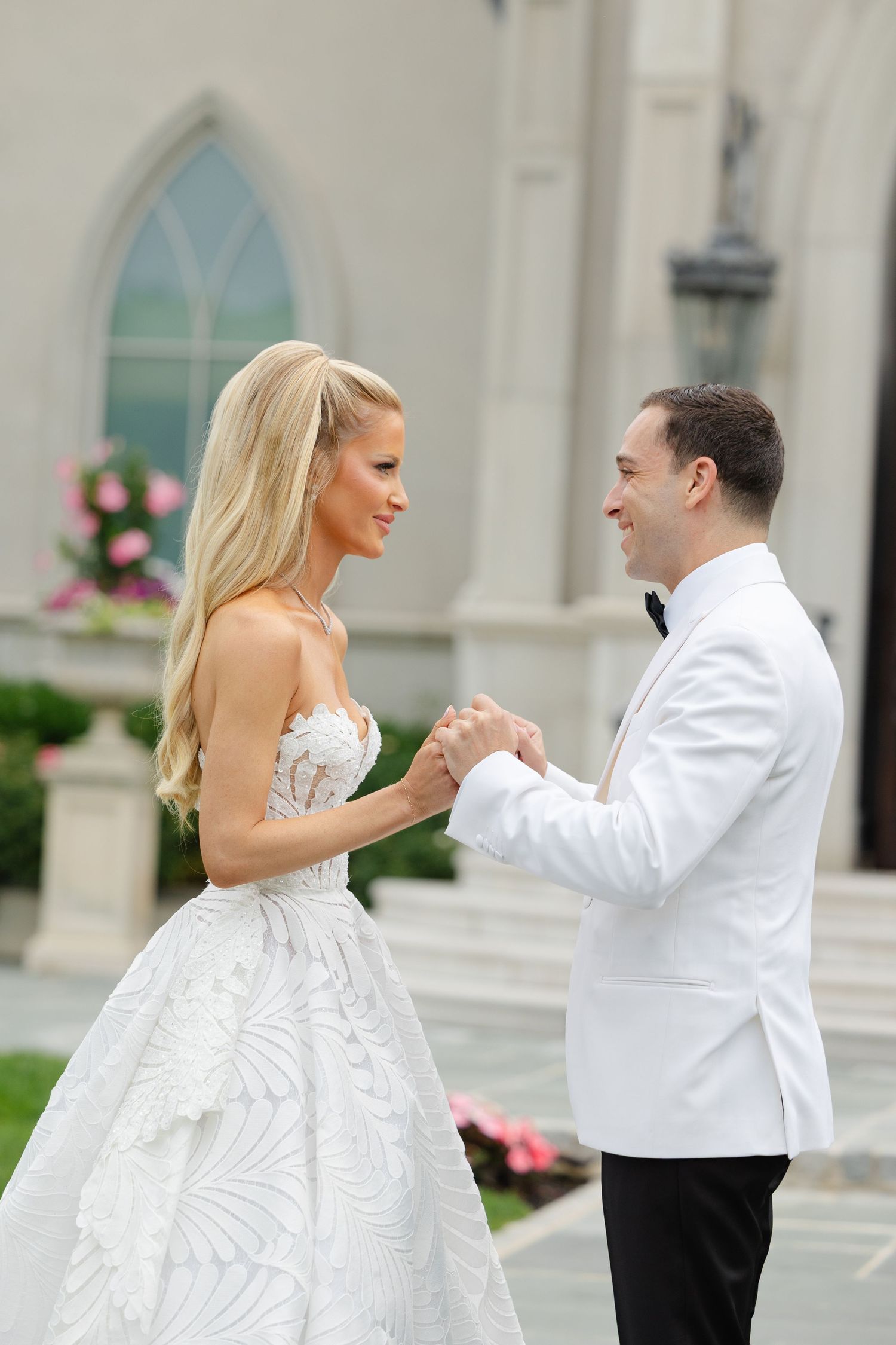 A couple in wedding attire dances together in a sequence of photos showing their elegant dance moves outside a church.