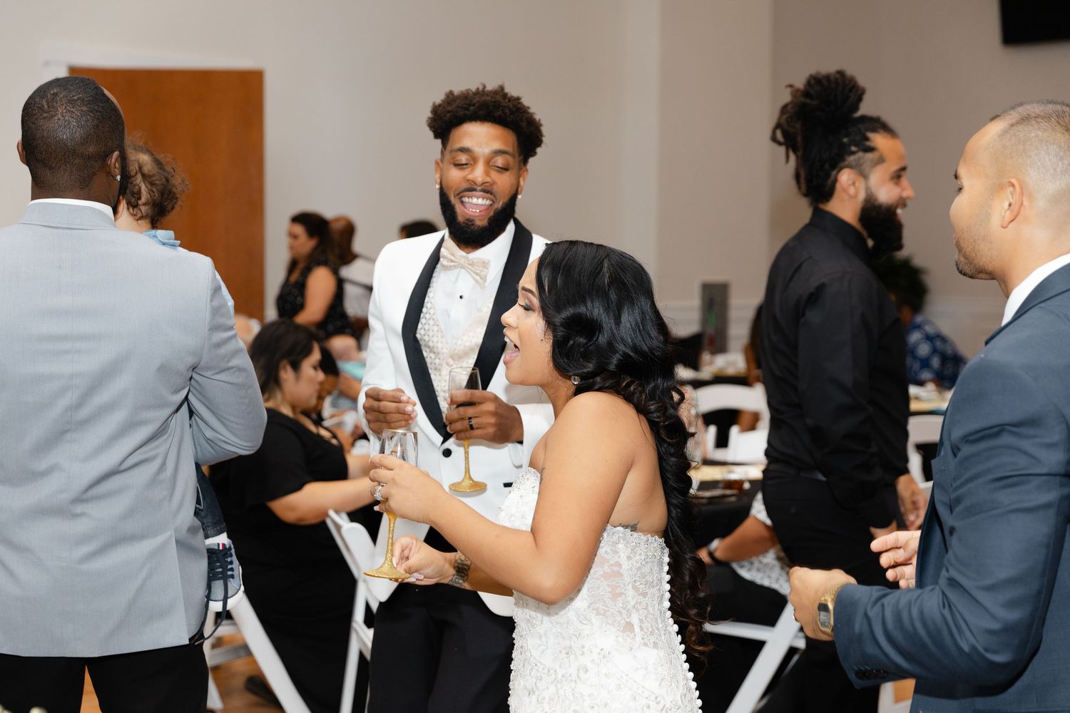 People enjoying a formal dinner event in business attire while socializing at round tables.