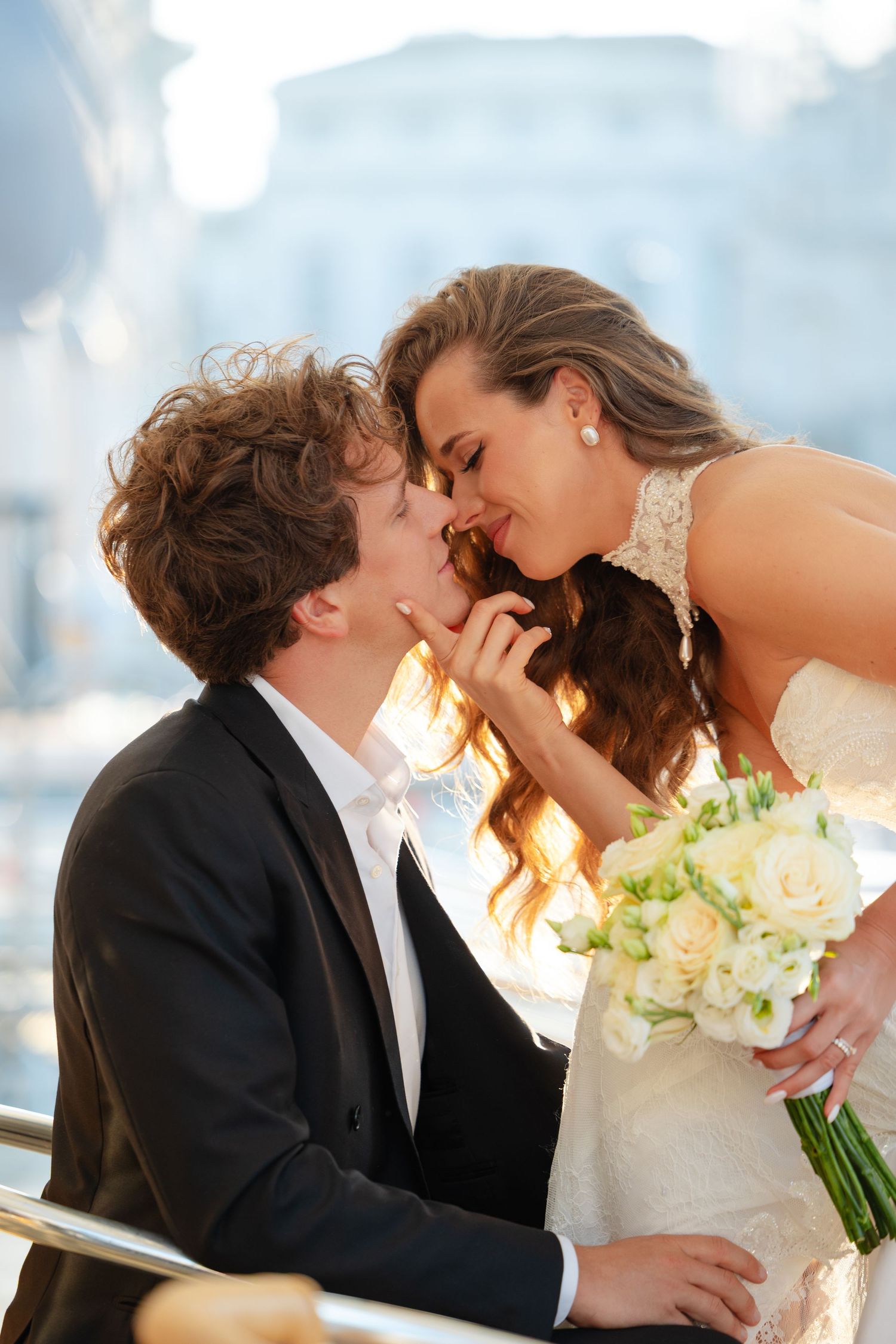 A romantic wedding kiss sequence showing a couple sharing intimate moments against a bright background.