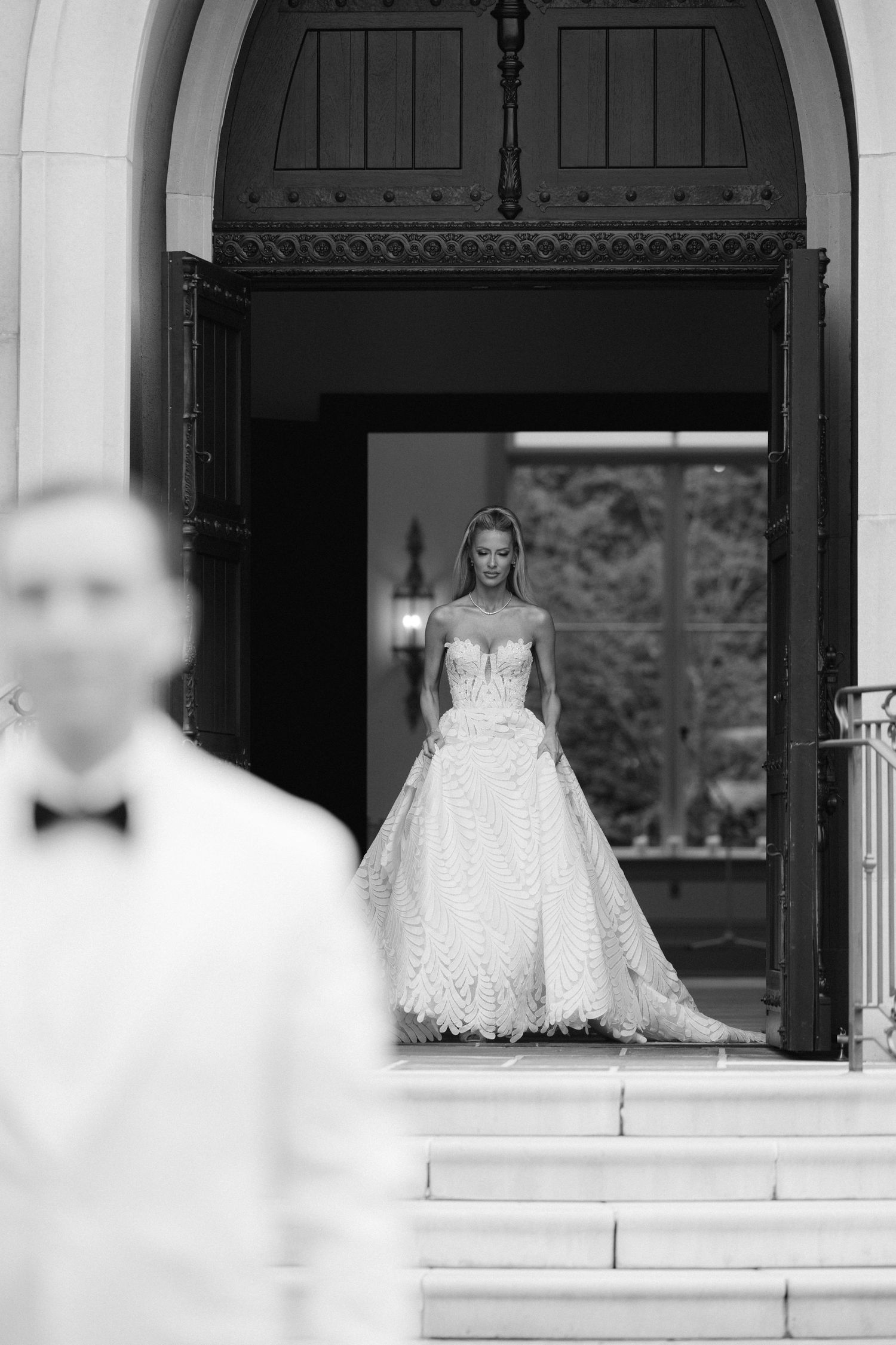 A series of black and white bridal portraits showing a person in a white wedding gown posing in doorway arches.