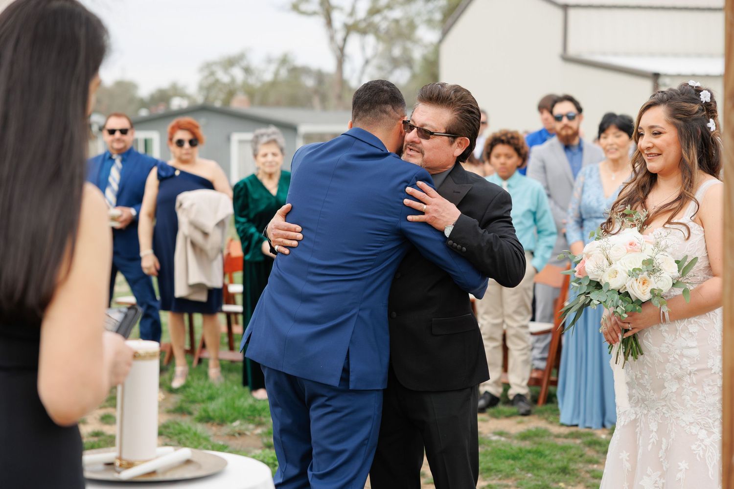 A couple shares intimate moments during their outdoor wedding celebration in a series of candid photographs.
