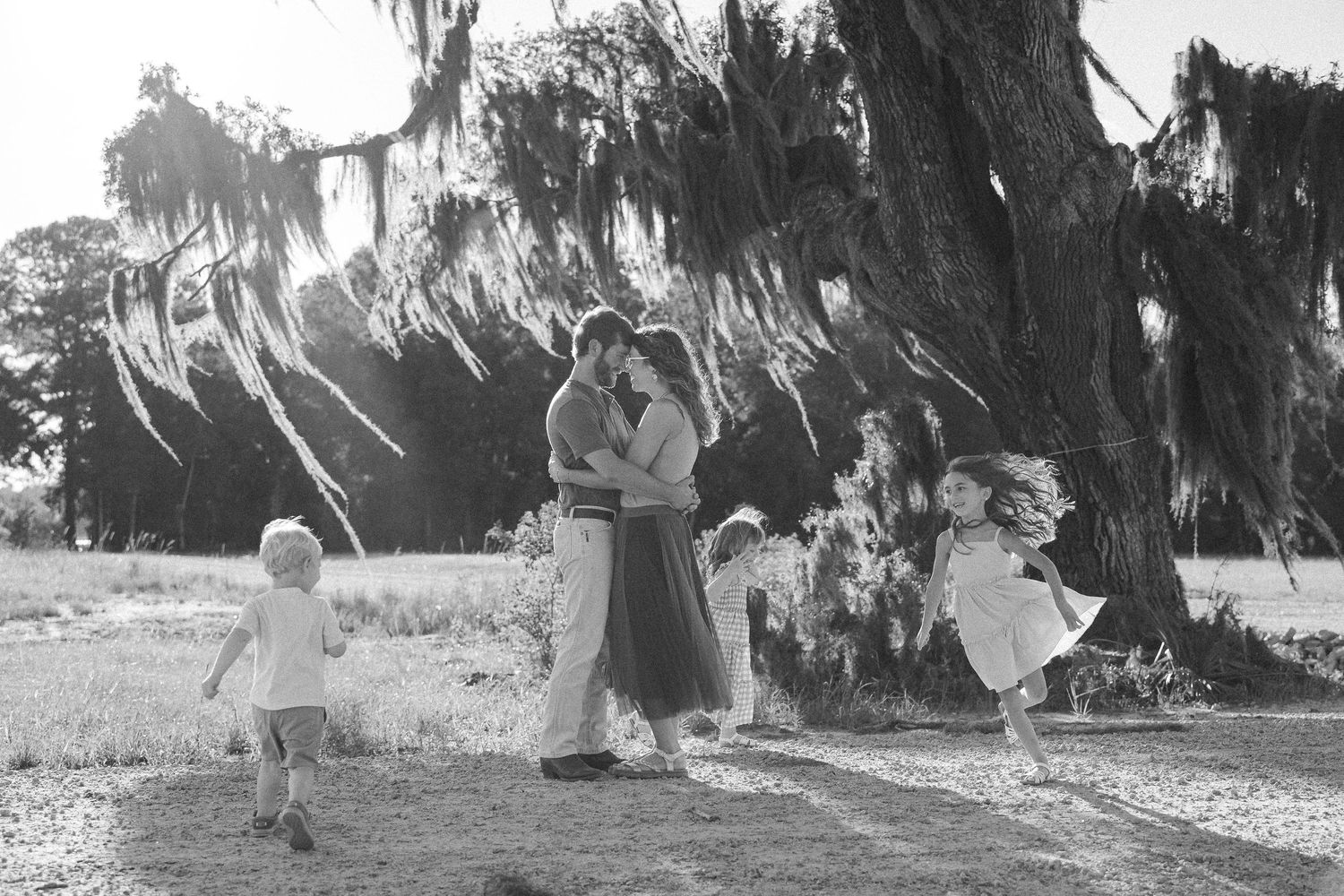 Black and white family photograph beneath a large oak tree with Spanish moss in the South Carolina Lowcountry.