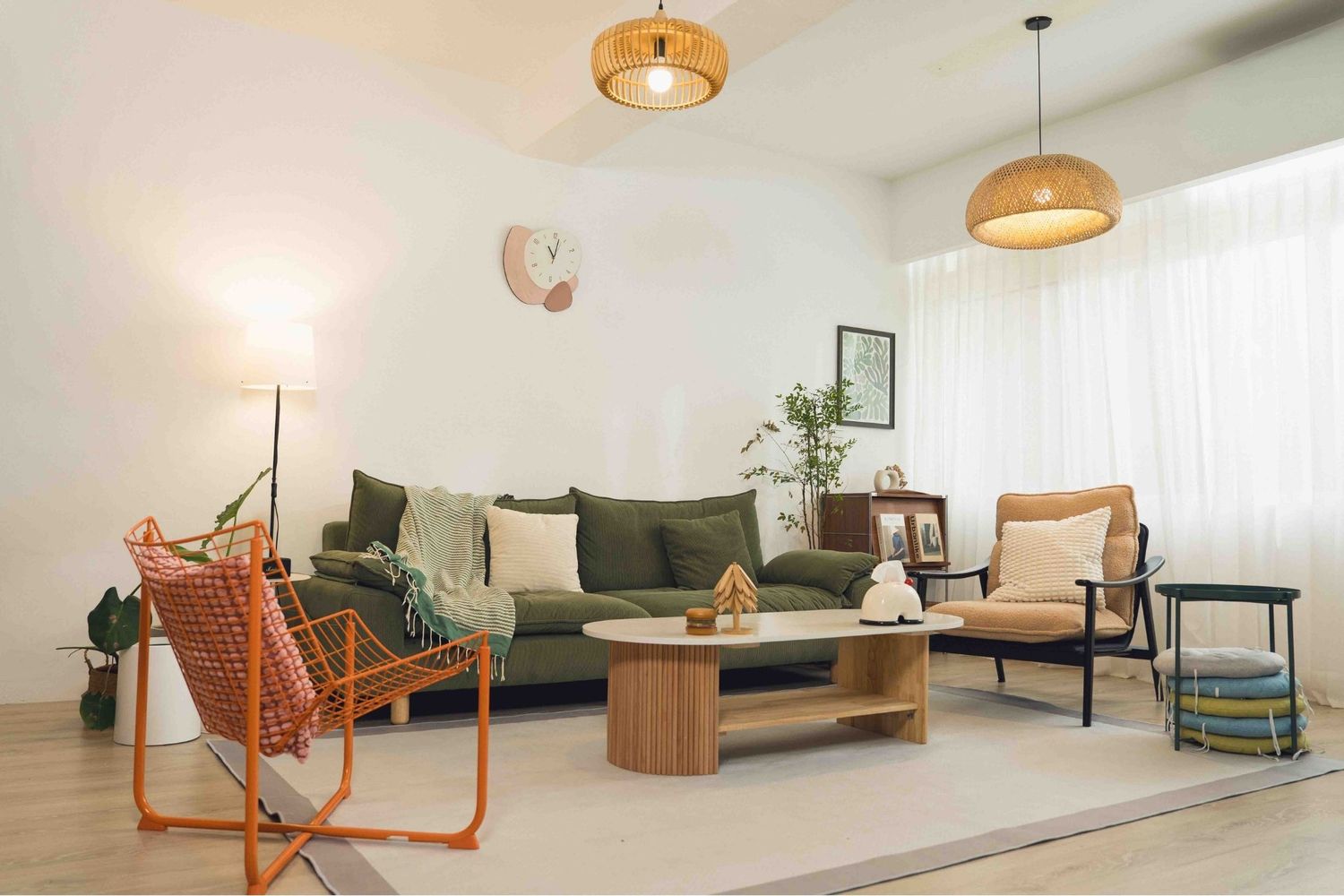 Modern apartment interior with rattan pendant lights, wood furniture, and minimalist Scandinavian design elements.