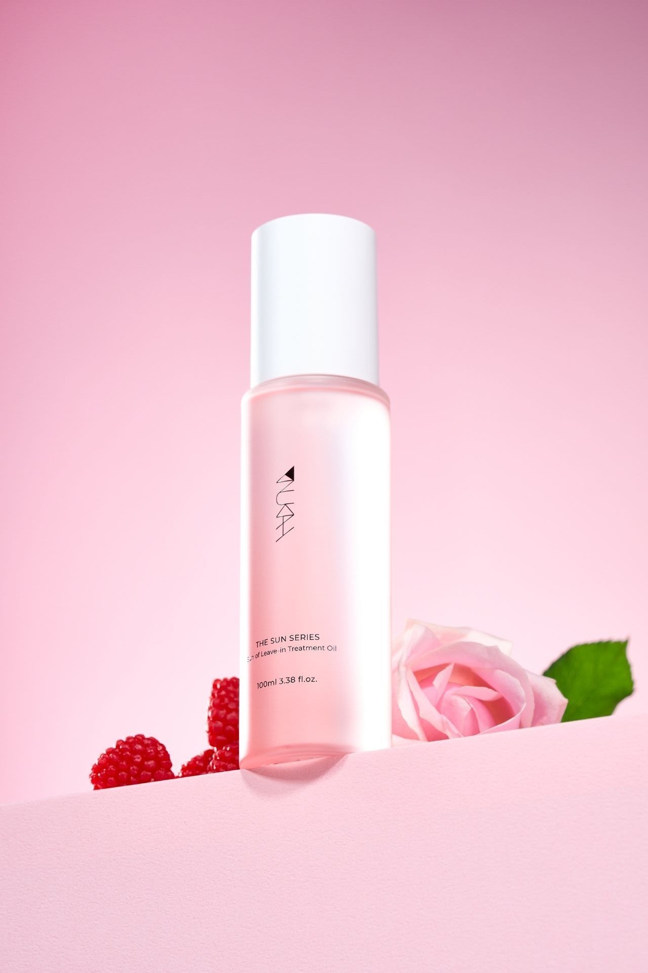 Pink skincare toner bottle with rose and raspberries on a soft pink background, part of a rose skin series.