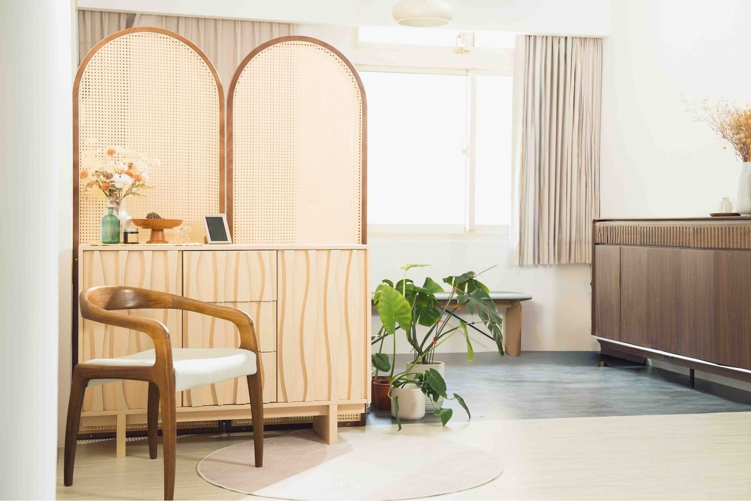 Modern spa interior with beige furniture, wooden paneling, and curtains creating a serene wellness atmosphere.