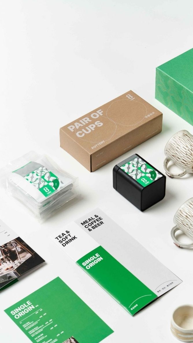Modern branding mockup featuring business cards, packaging boxes and stationery in green and white minimalist design.
