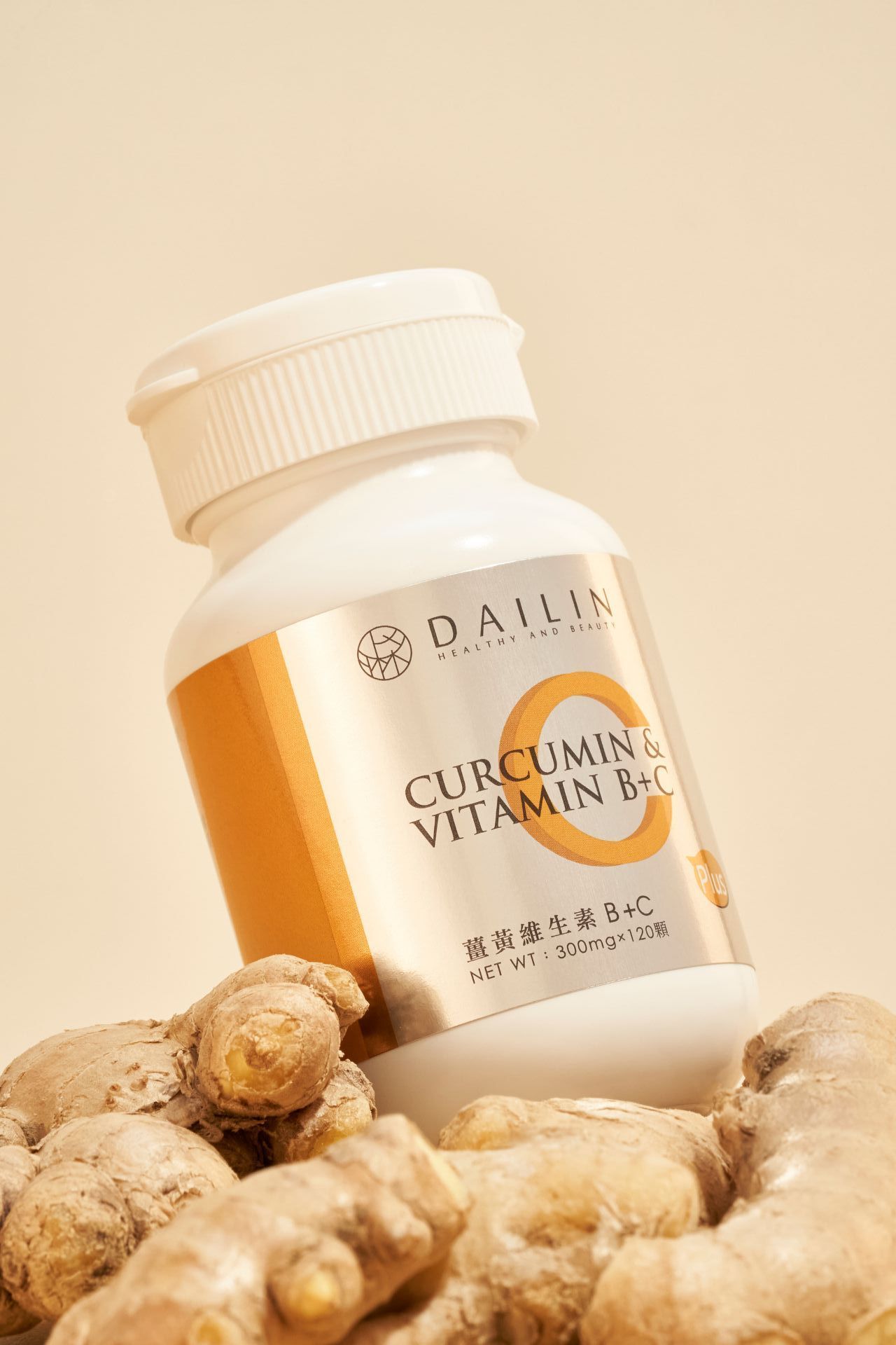 Fresh ginger root displayed with white supplement bottles containing curcumin and vitamin B6C on beige background.