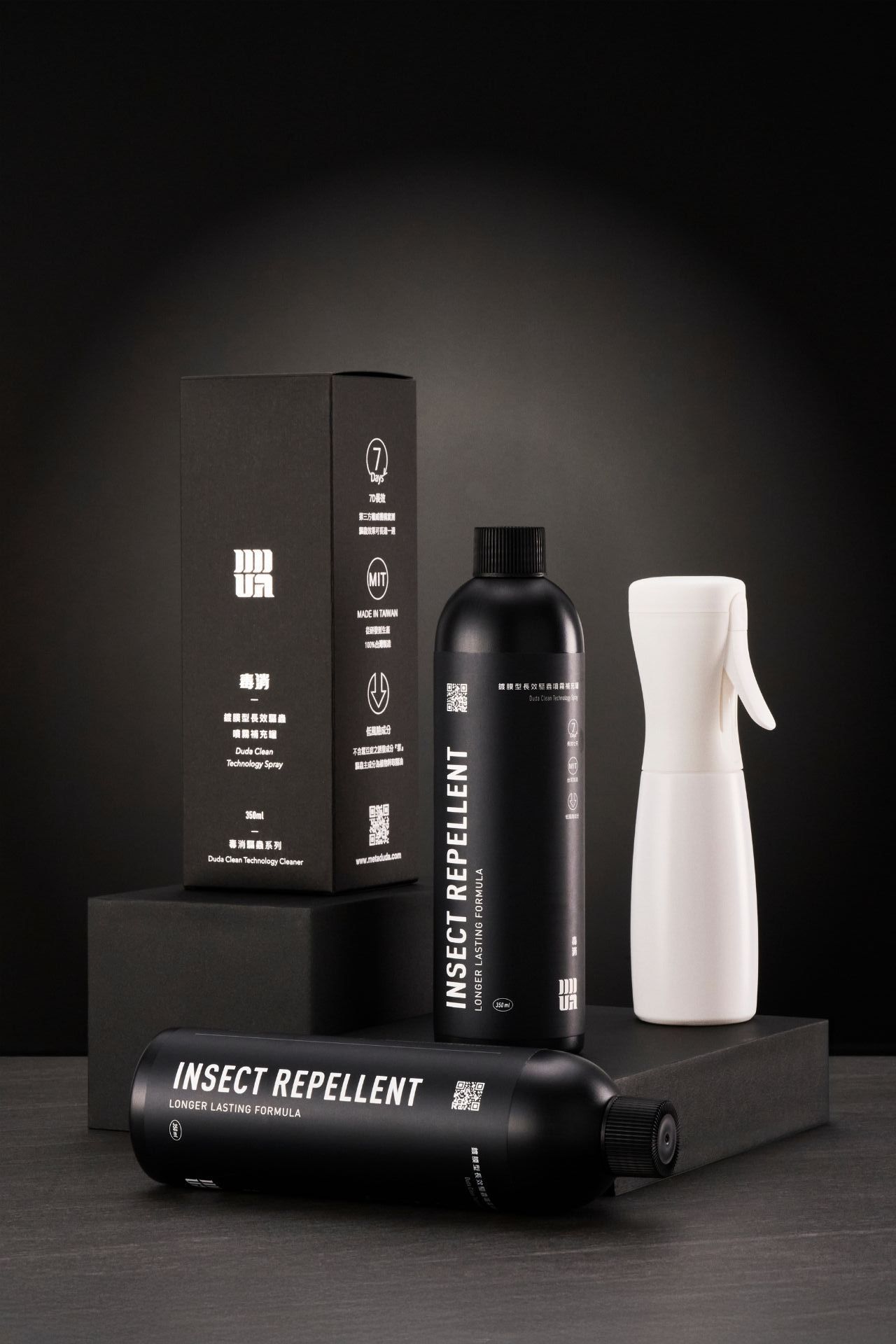 Sleek black cosmetic product packaging with minimalist design elements arranged against dark background.