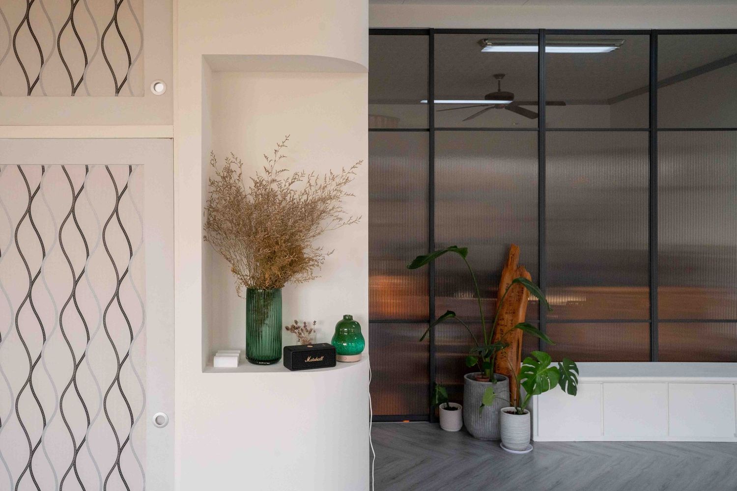 Modern office interior with white walls and zigzag patterned design elements along a corridor.
