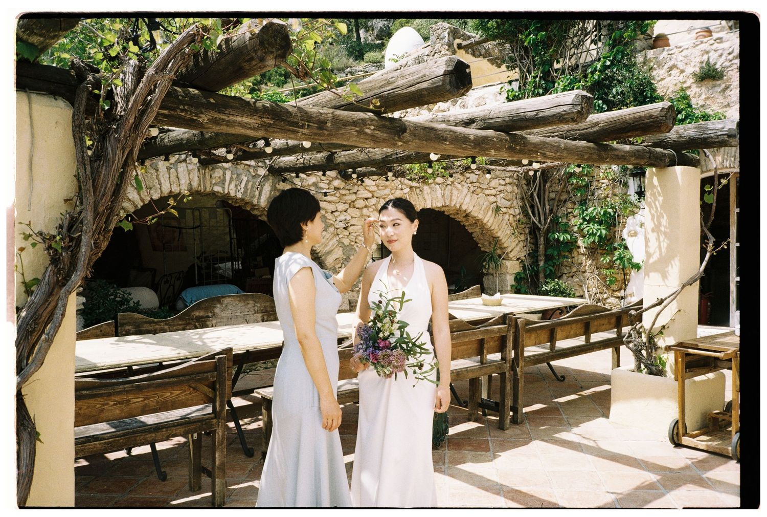 Bride and mom before ceremony walk in in Sitges