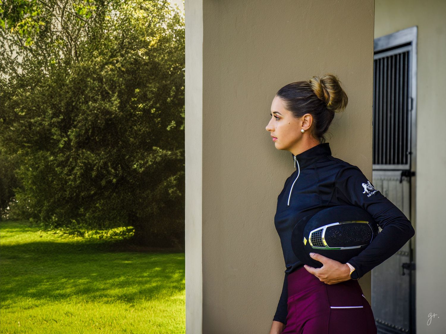 Athletic wear details shown against stable building background.