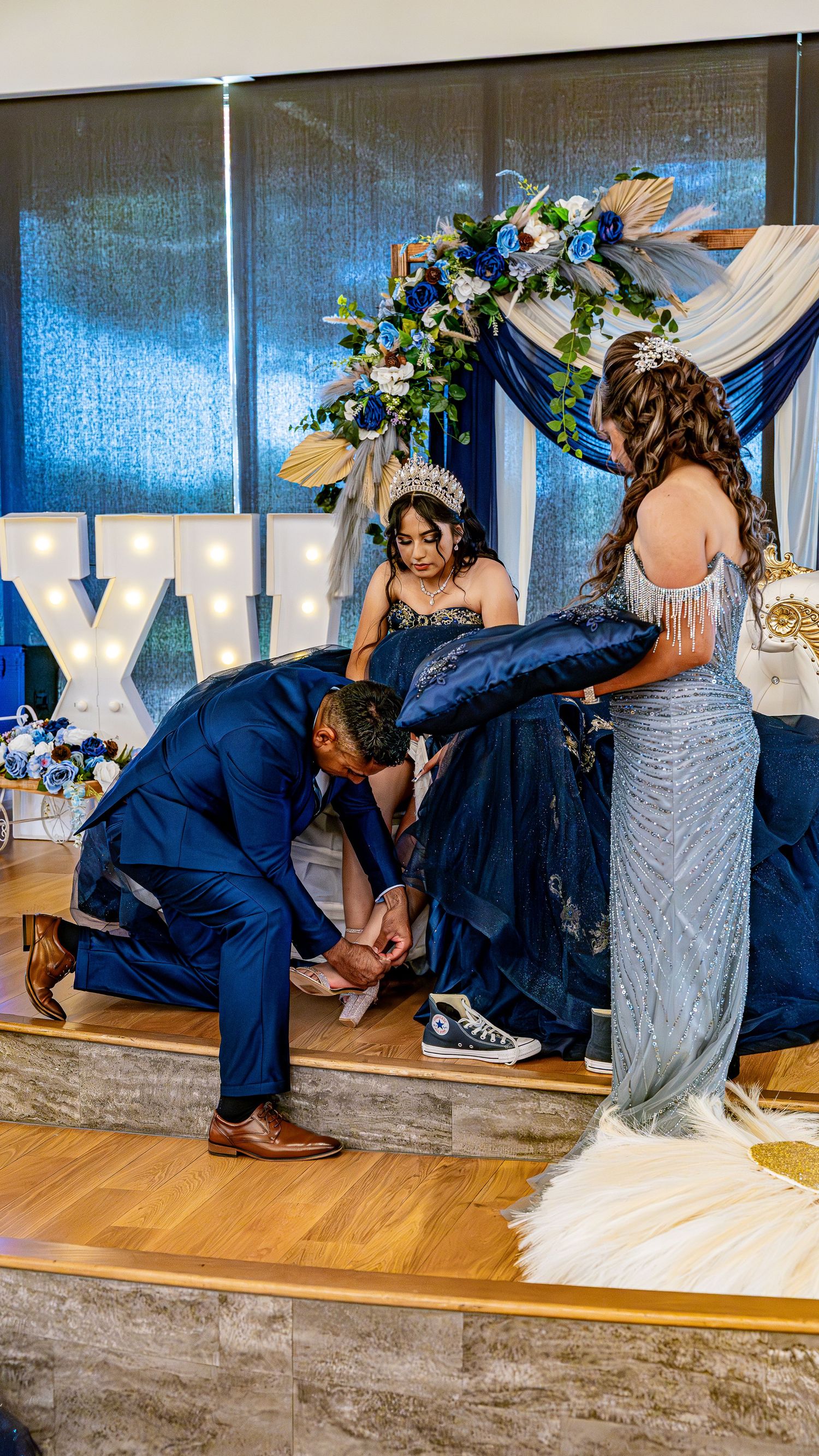A sequence showing playful dance moves and dips in elegant navy blue formal wear.