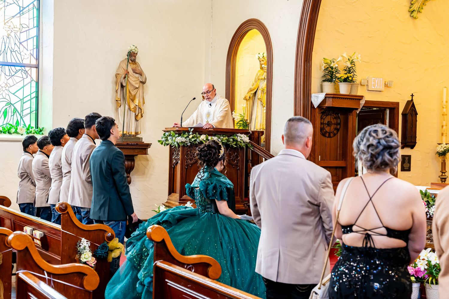 Church ceremony in progress with guests seated in pews and religious artwork adorning the walls.