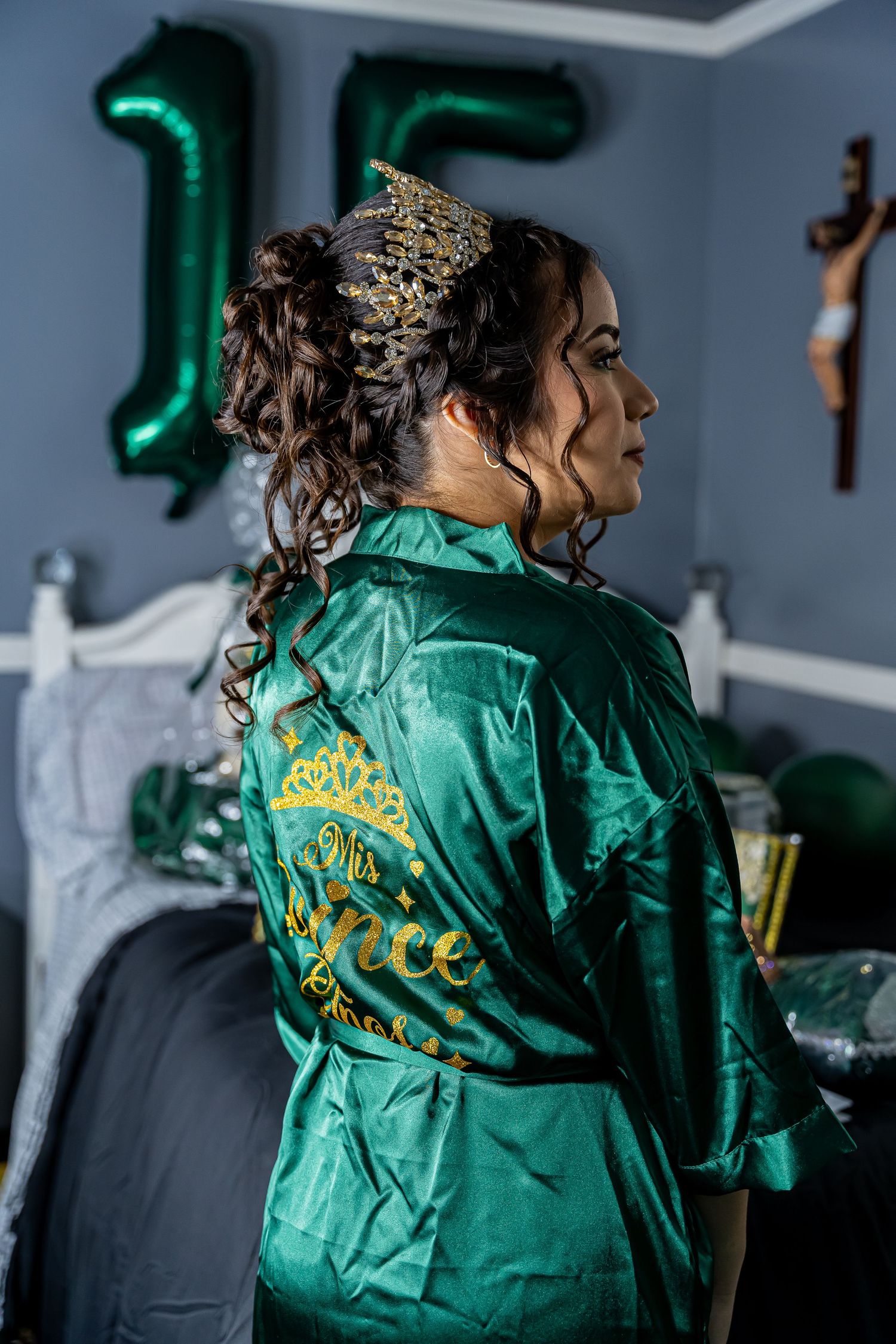 Emerald green satin robe with gold embroidery detail shown from behind.