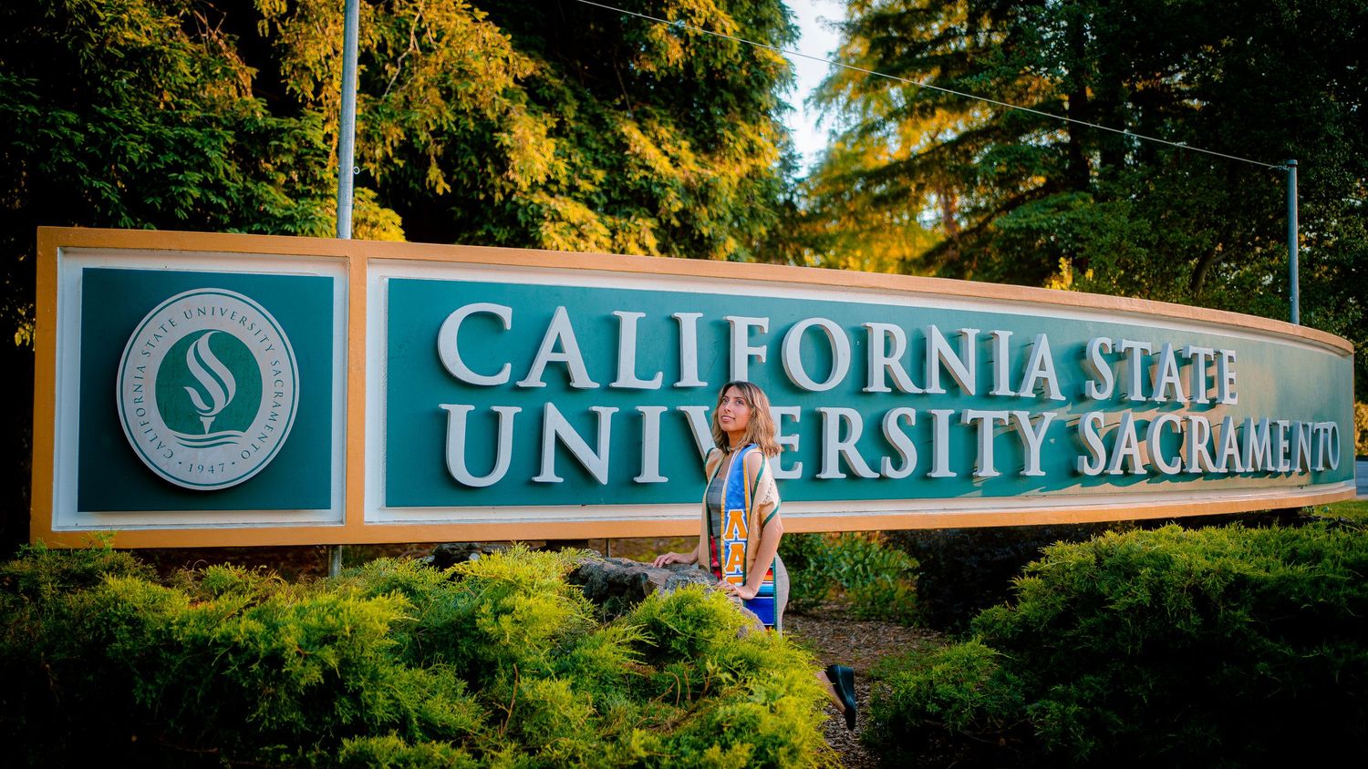 Wide panoramic view of California State University Sacramento entrance sign.