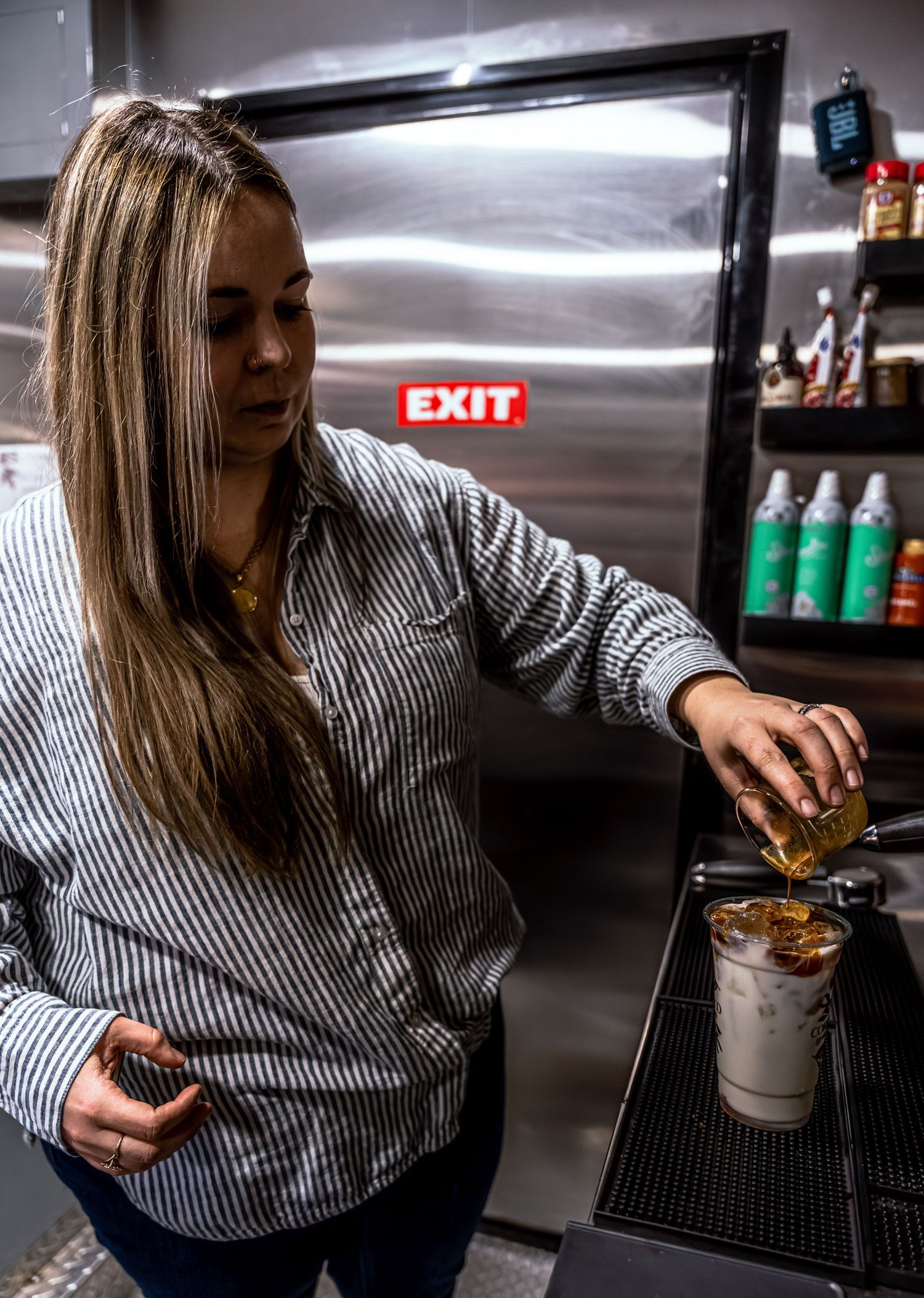 Sequential photos of someone preparing food in a commercial kitchen wearing striped clothing.