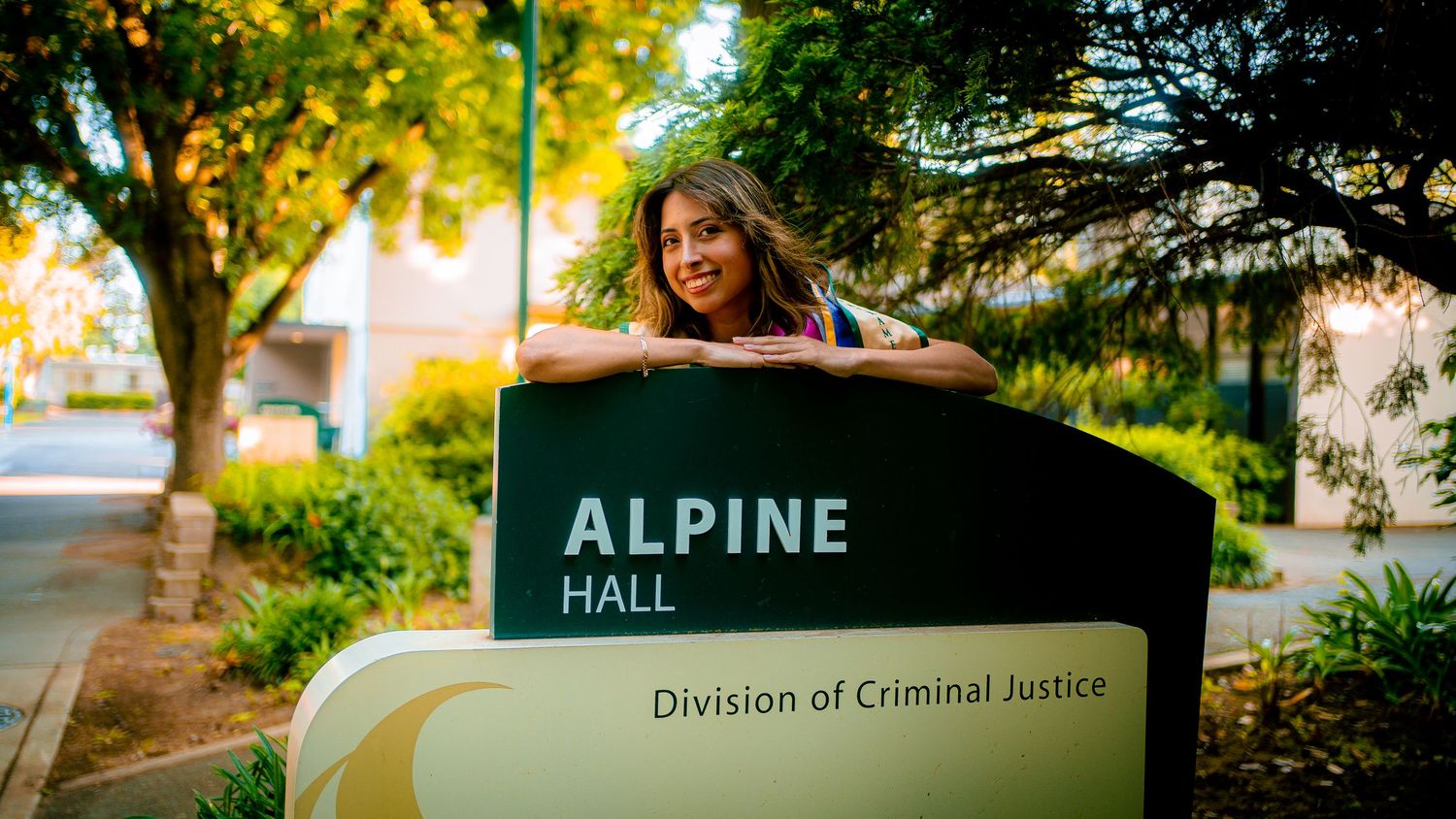 Campus signage for Alpine Hall and Division of Criminal Justice.
