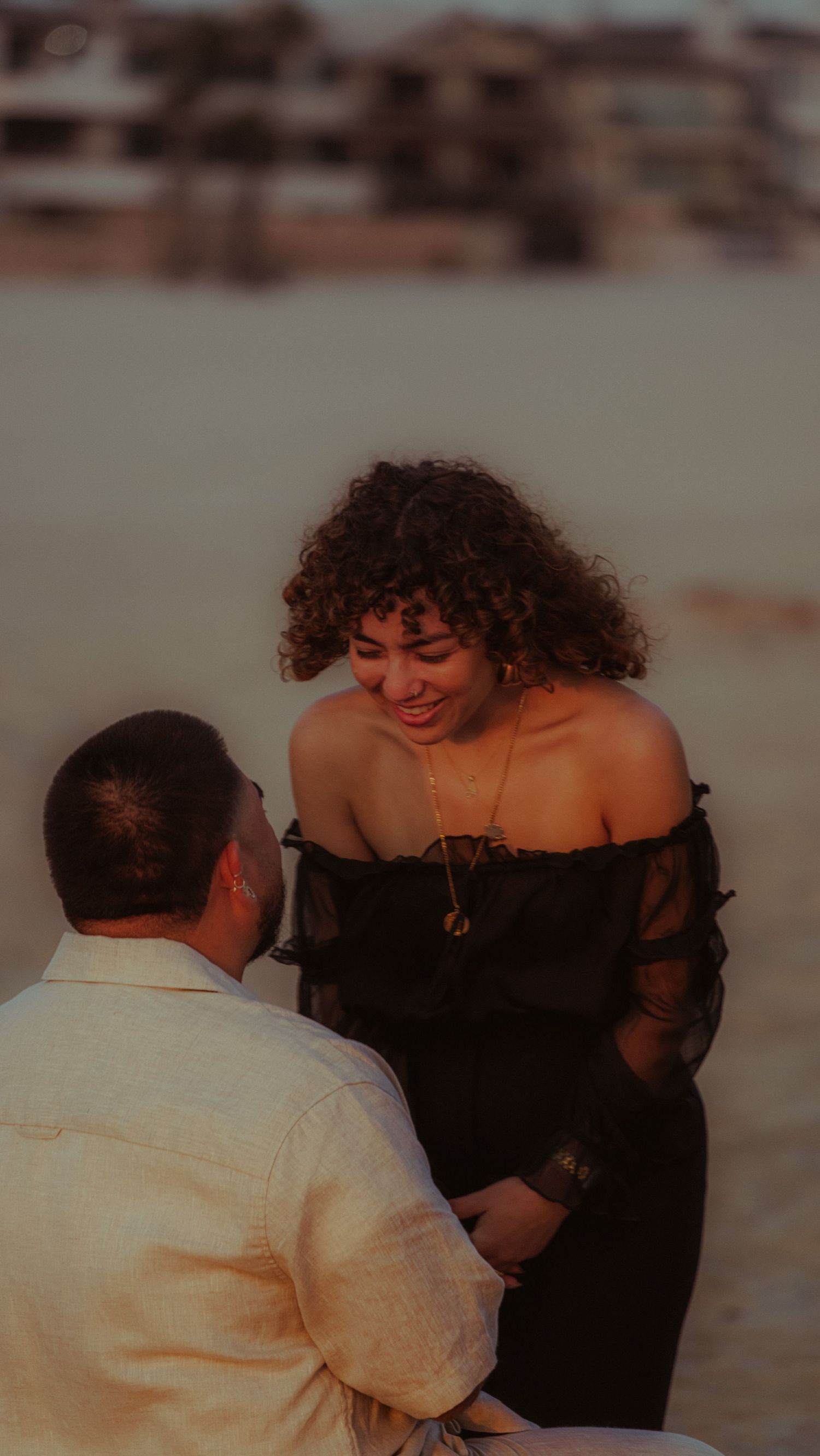 A tender moment captured between two people at sunset.