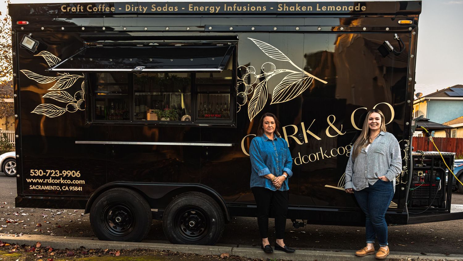 Food truck exterior with customers waiting in line.