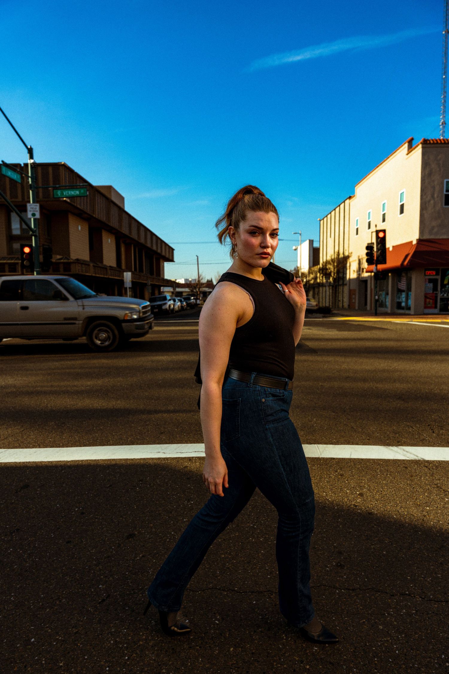 Street fashion photography with urban backdrop during golden hour.