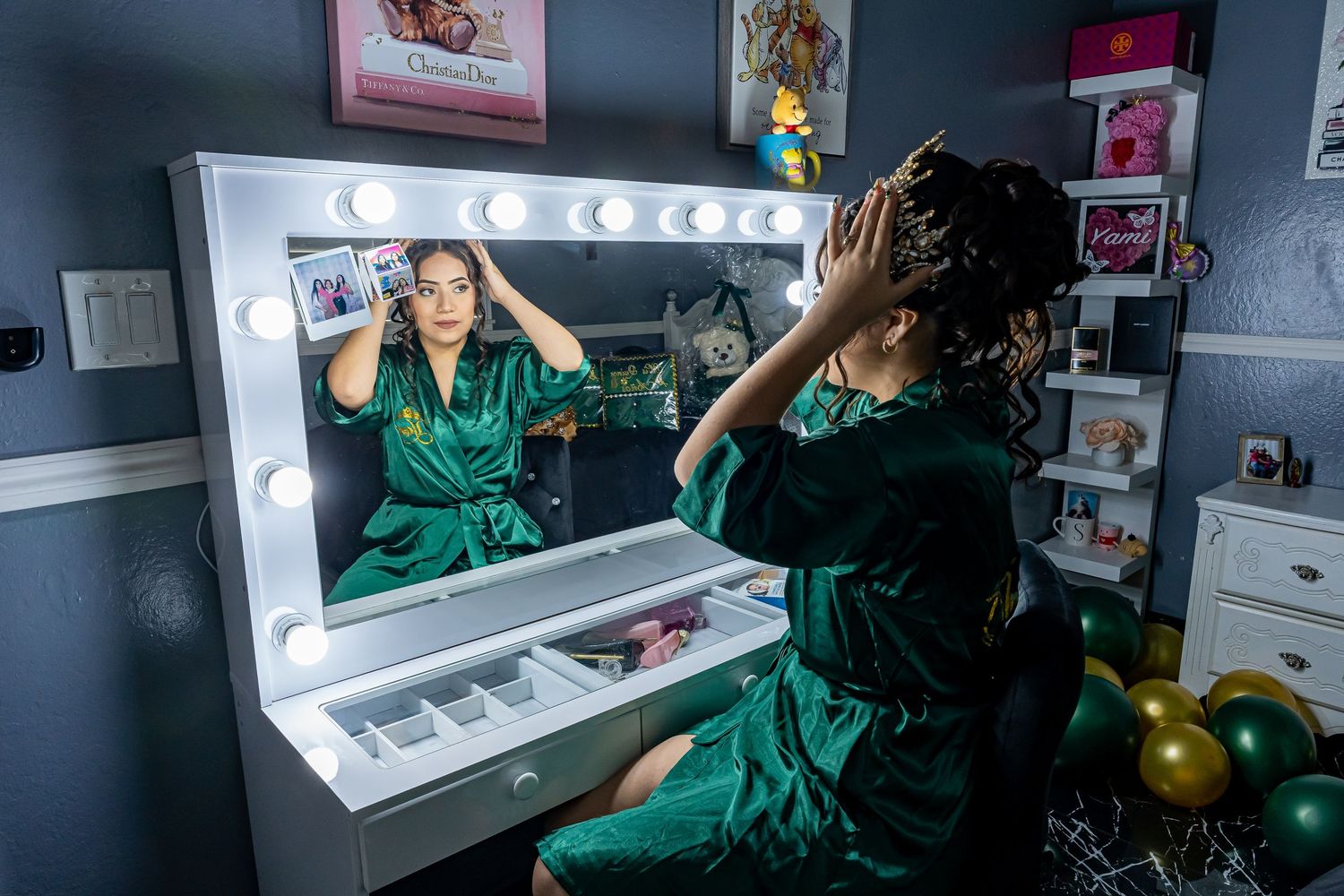 Vanity mirror setup with bright lights in blue-walled room.