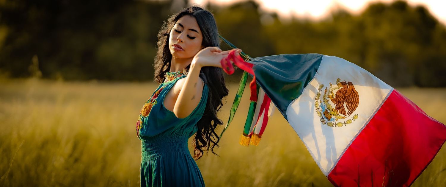 Colorful fashion scene with flowing fabrics in a sun-drenched meadow.