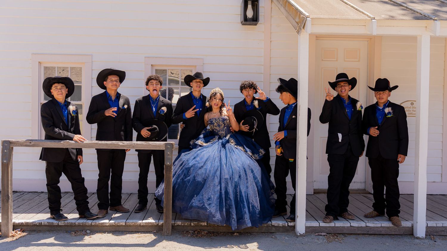People in western attire gather outside for a formal event celebration.