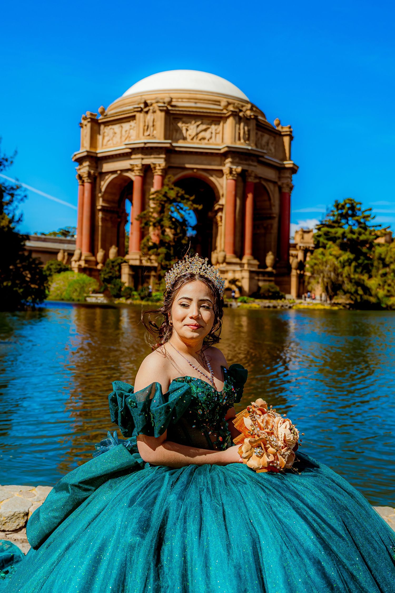 A quinceañera photo session at Palace of Fine Arts in San Francisco featuring a teal ballgown against the iconic architecture.