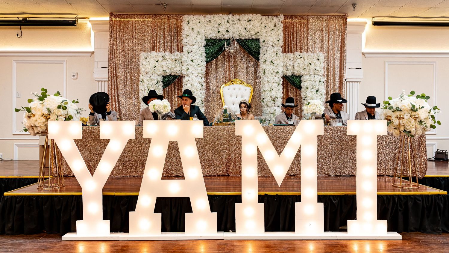Decorative light-up letters spelling text against a neutral wall at an event venue.