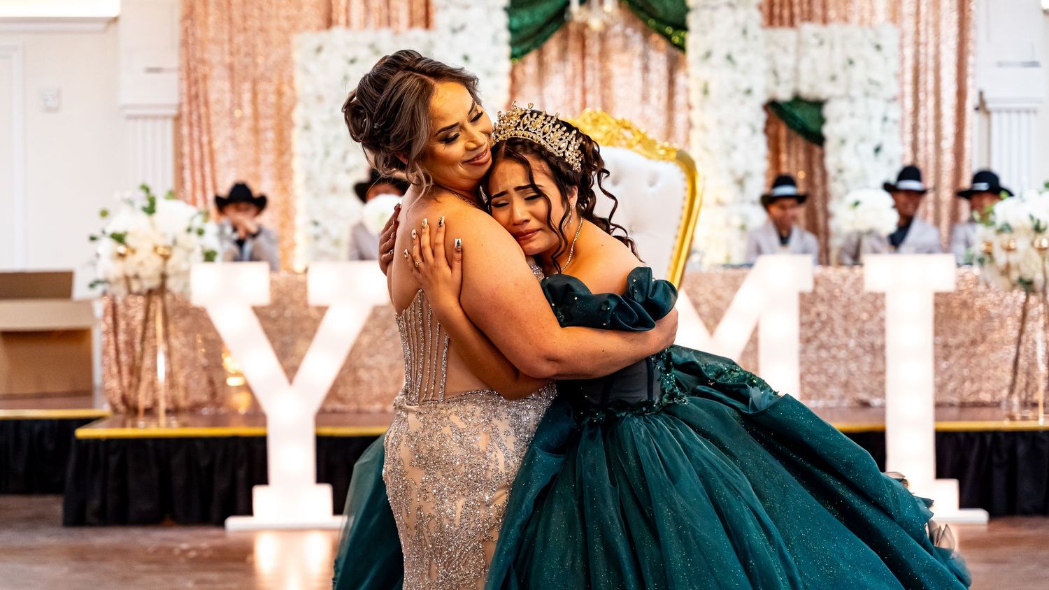 Ballroom dancers performing choreographed dance moves at a formal celebration event.