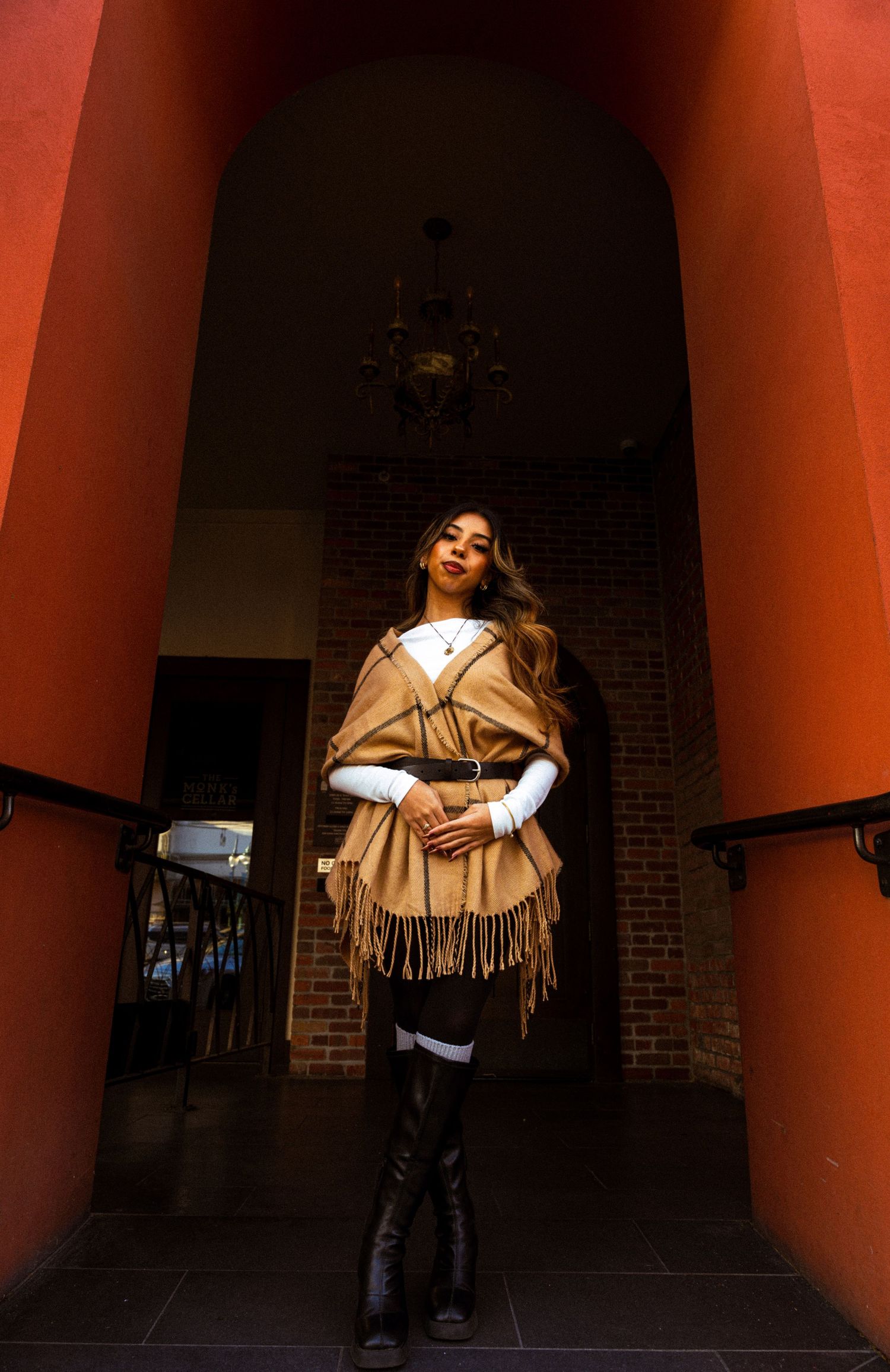 Artistic fashion shots under orange-lit archways showing movement and dramatic poses.