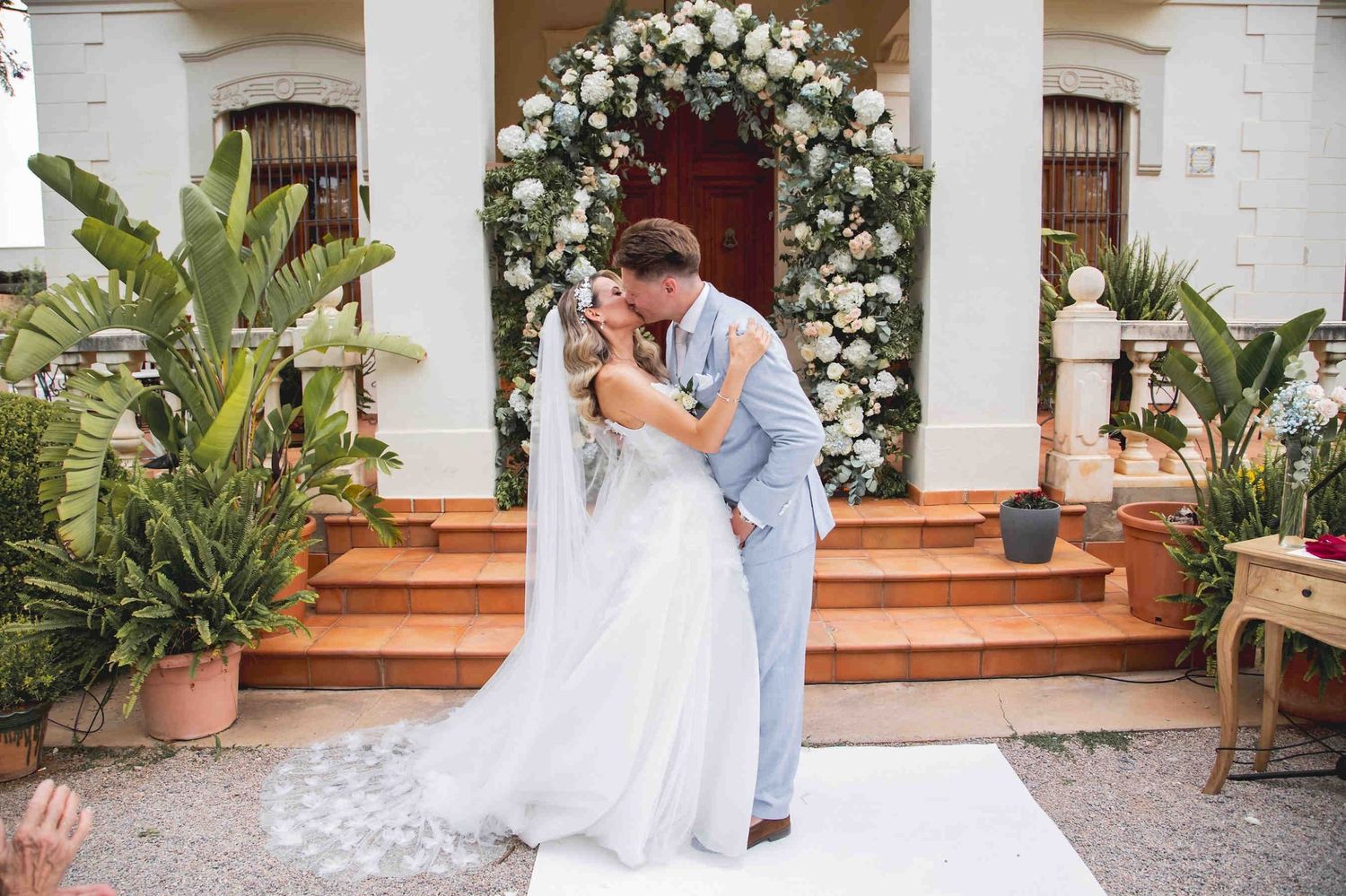 A destination wedding couple sharing a moment on the gravel esplanade of the prestigious Huerto San Rafael estate.