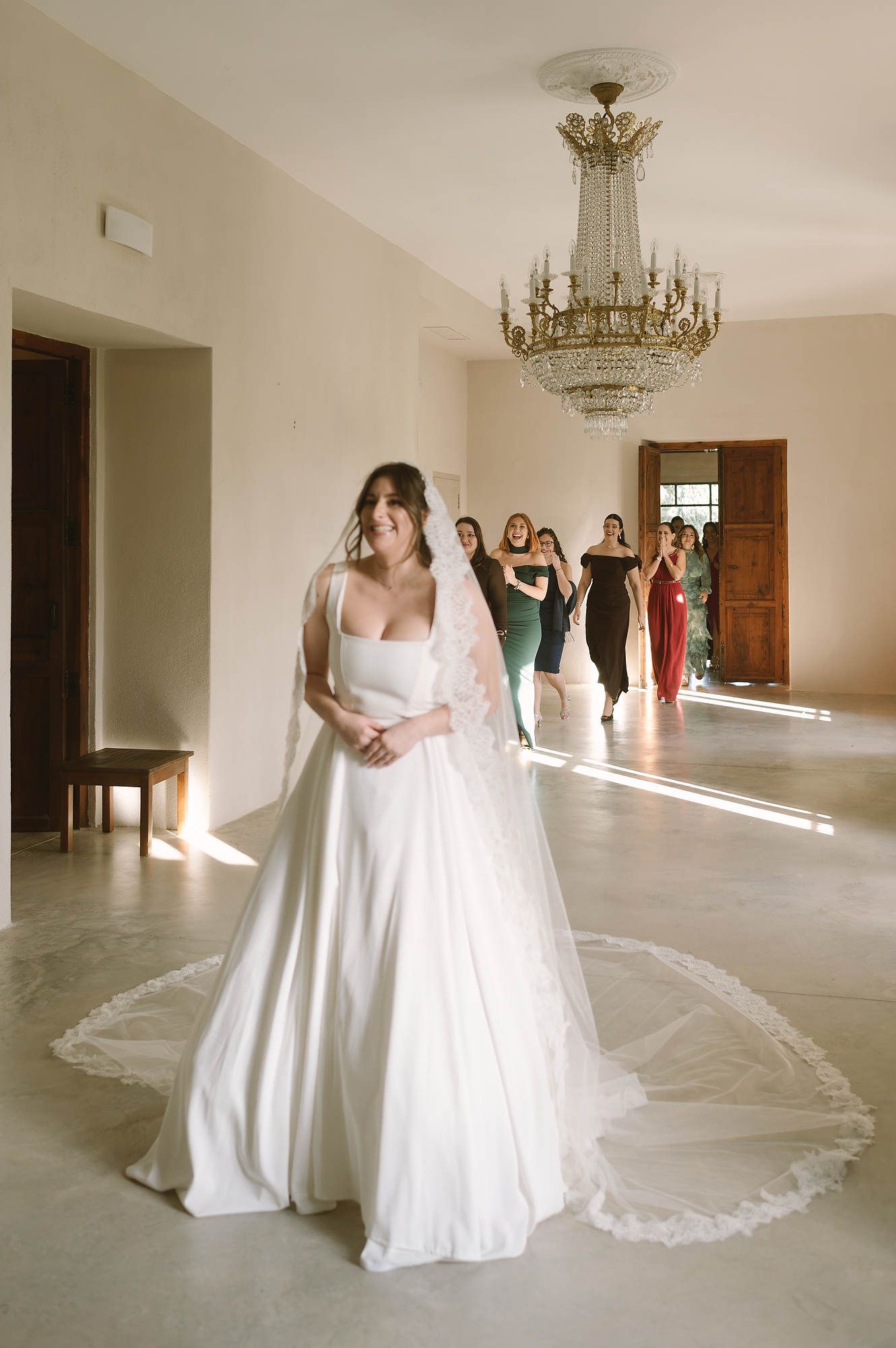 Emotional moment as bridesmaids see the bride for the first time during the wedding preparation at Mas d’Alzedo