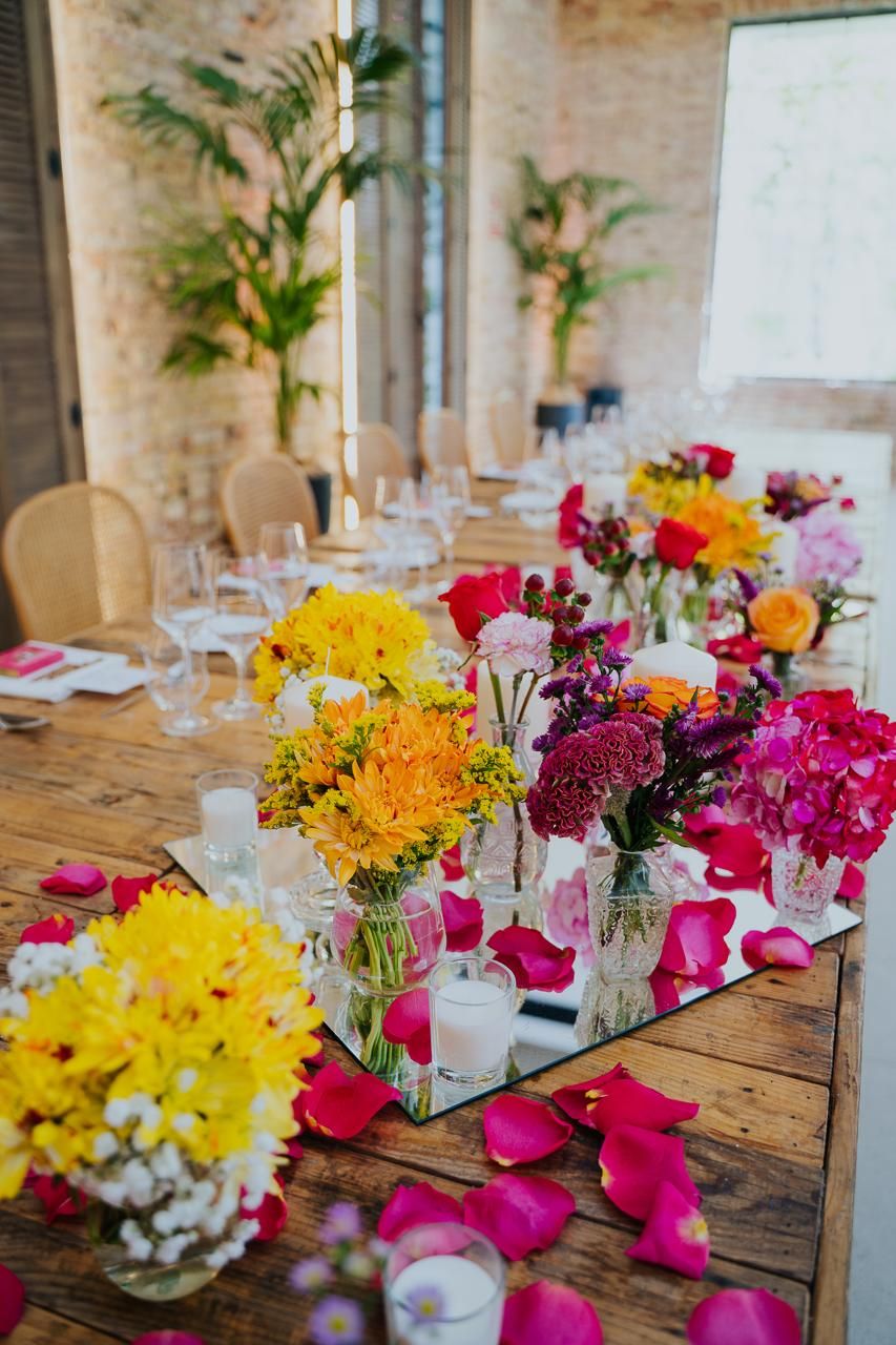 Elaborately decorated head table for the two brides at their Indian wedding reception.