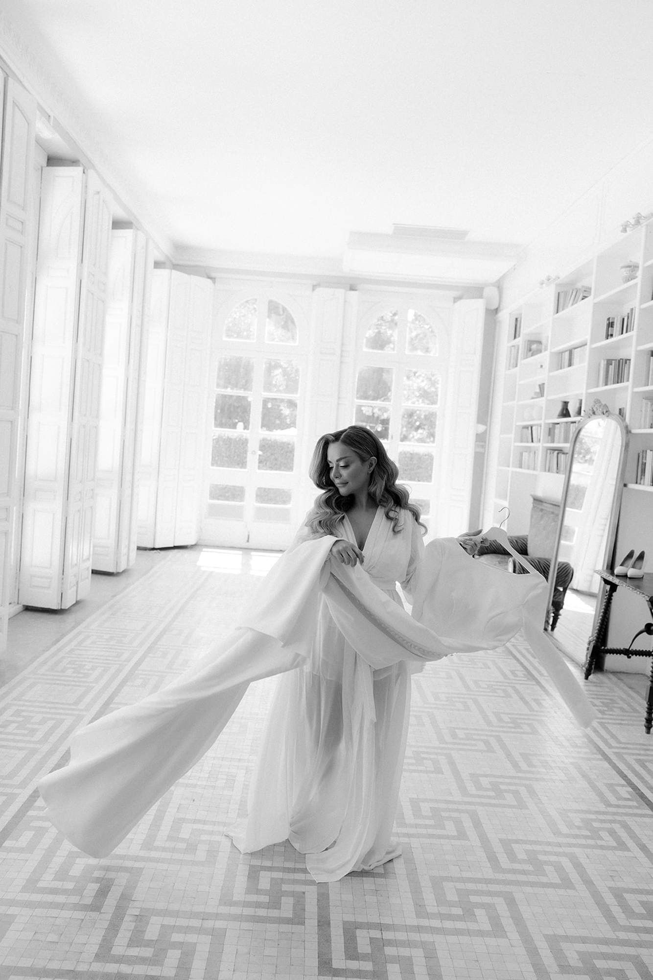 Happy bride twirling with her wedding gown after professional makeup and hair styling at Finca Torrefiel estate in Valencia.