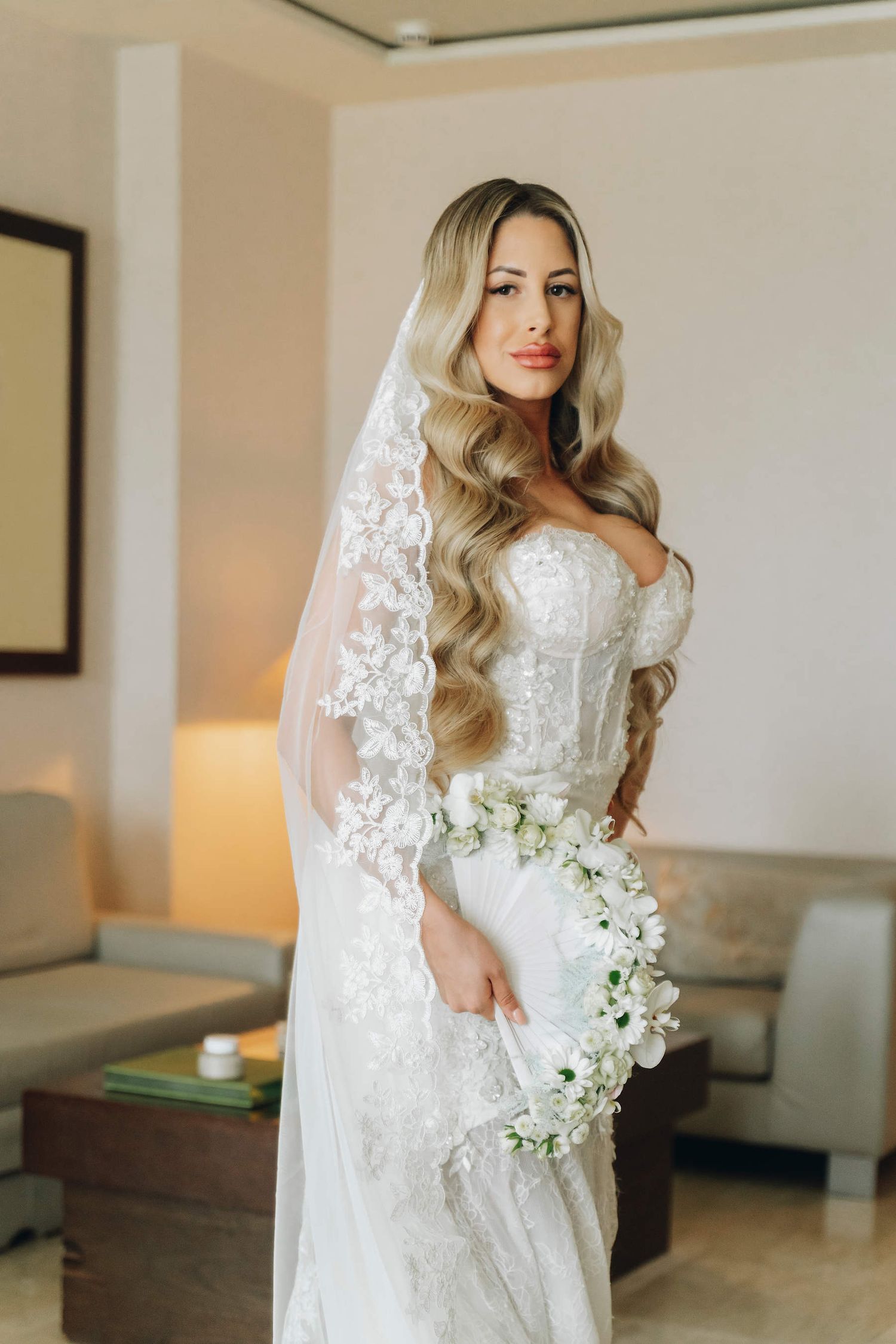 A timeless classic wedding bun hairstyle that complements the grand architecture of Las Arenas Hotel in Valencia.