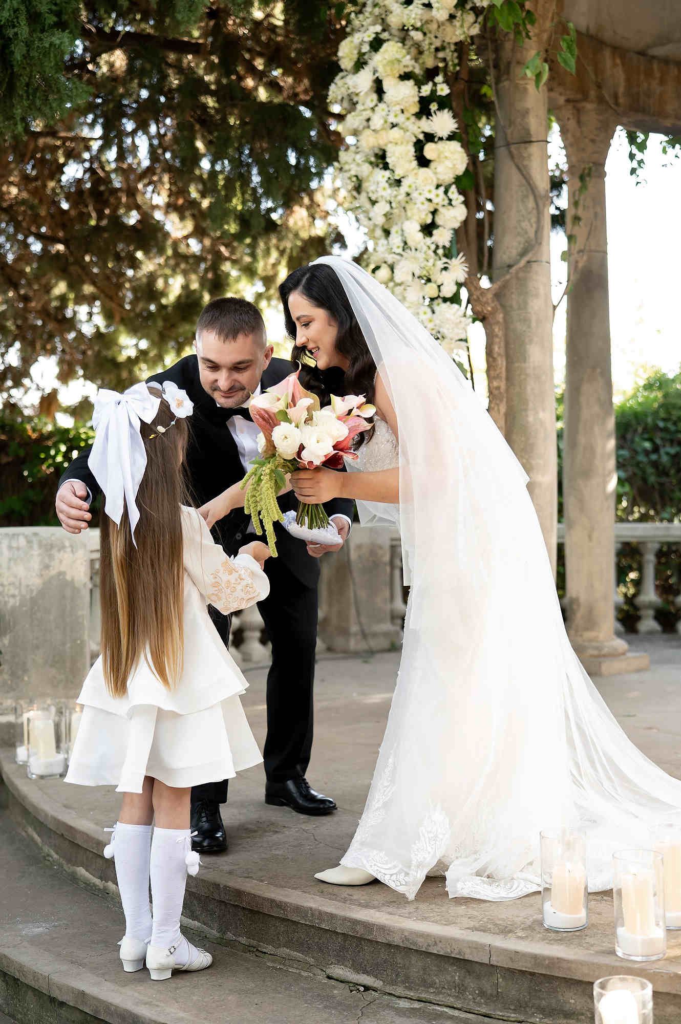 A touching moment during the wedding ceremony as a child presents the rings to the groom and bride