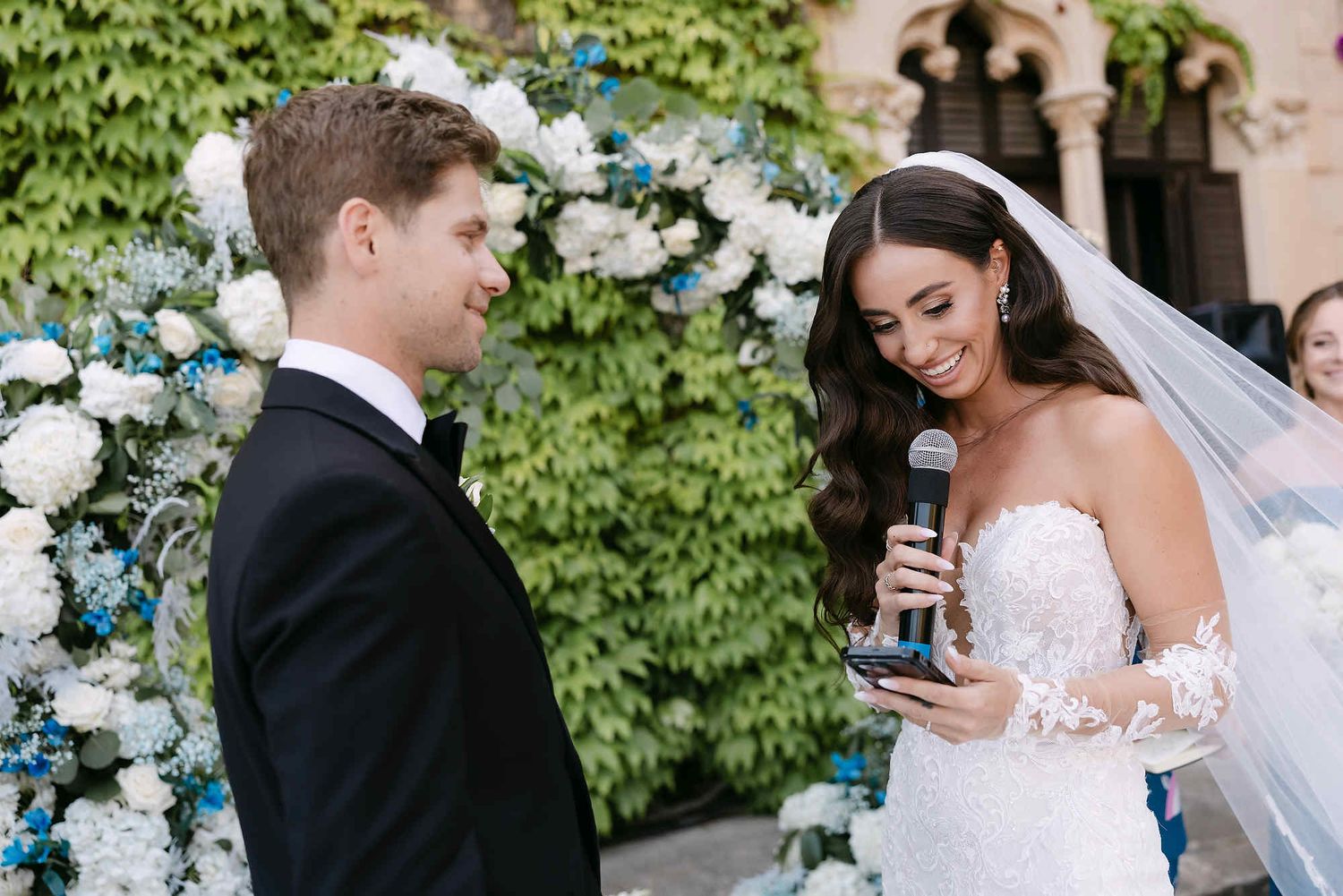 Close-up of the bride reading her wedding vows, highlighting her professional bridal makeup and elegant hairstyle by Anastasia Larionova