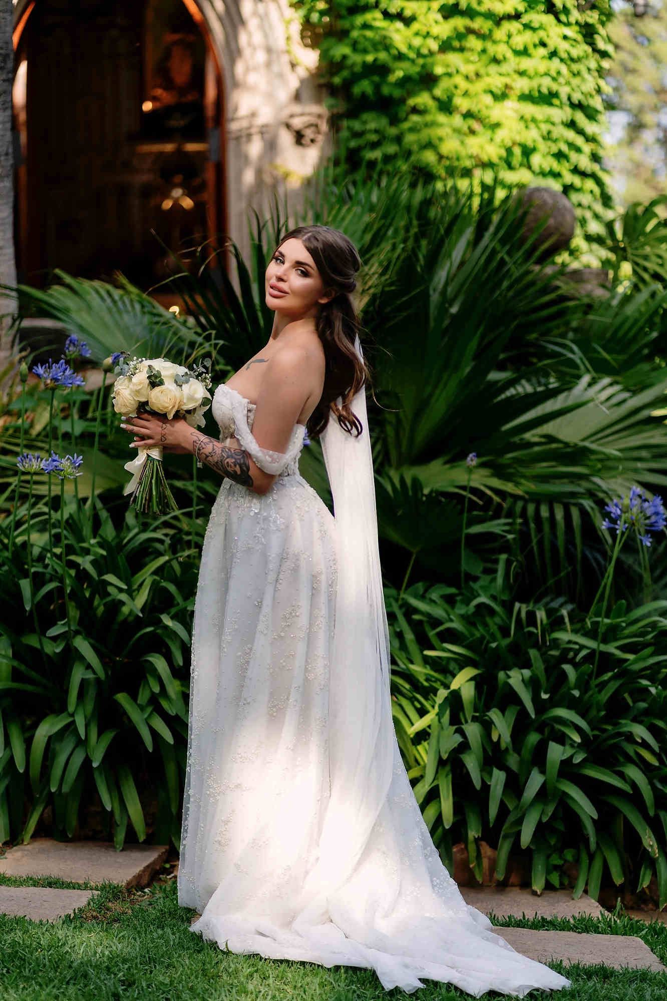 A romantic bride posing in the lush botanical gardens of Casa Santonja for a luxury destination wedding near Denia and Valencia