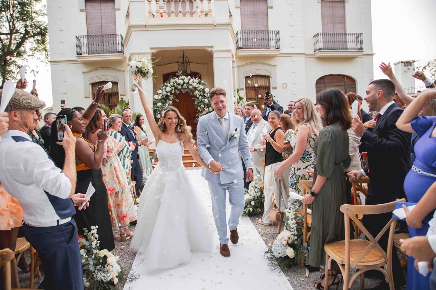 Luxury outdoor wedding ceremony setup in front of the iconic manor house at Huerto San Rafael, Valencia.