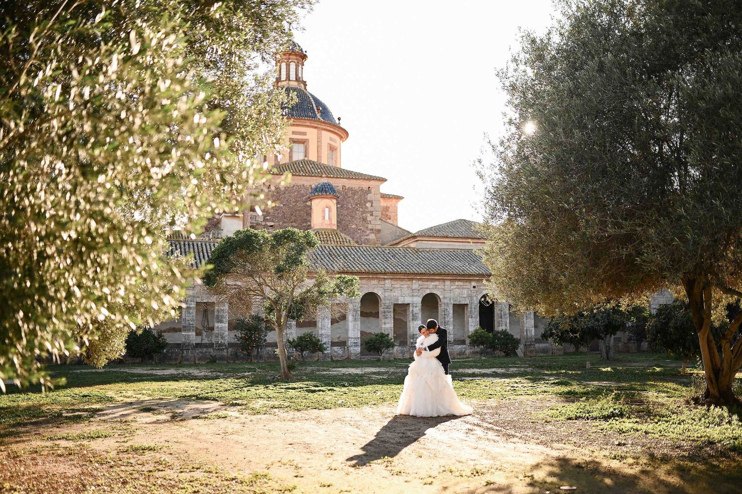Newlyweds at La Cartoixa d'Ara Christi monastery. Professional bridal styling and makeup for a destination wedding