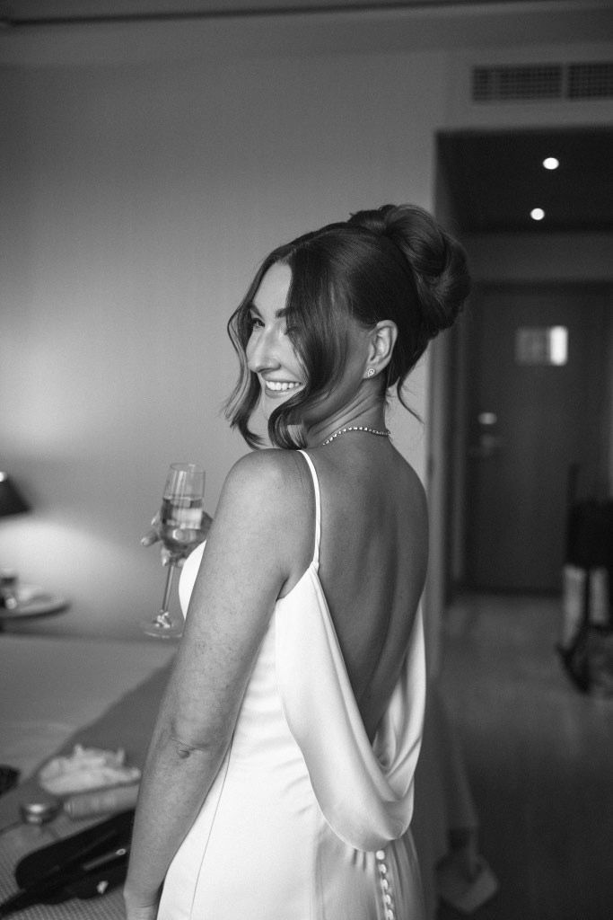 A stunning bride with finished professional makeup and hair styling ready for her Mediterranean wedding celebration