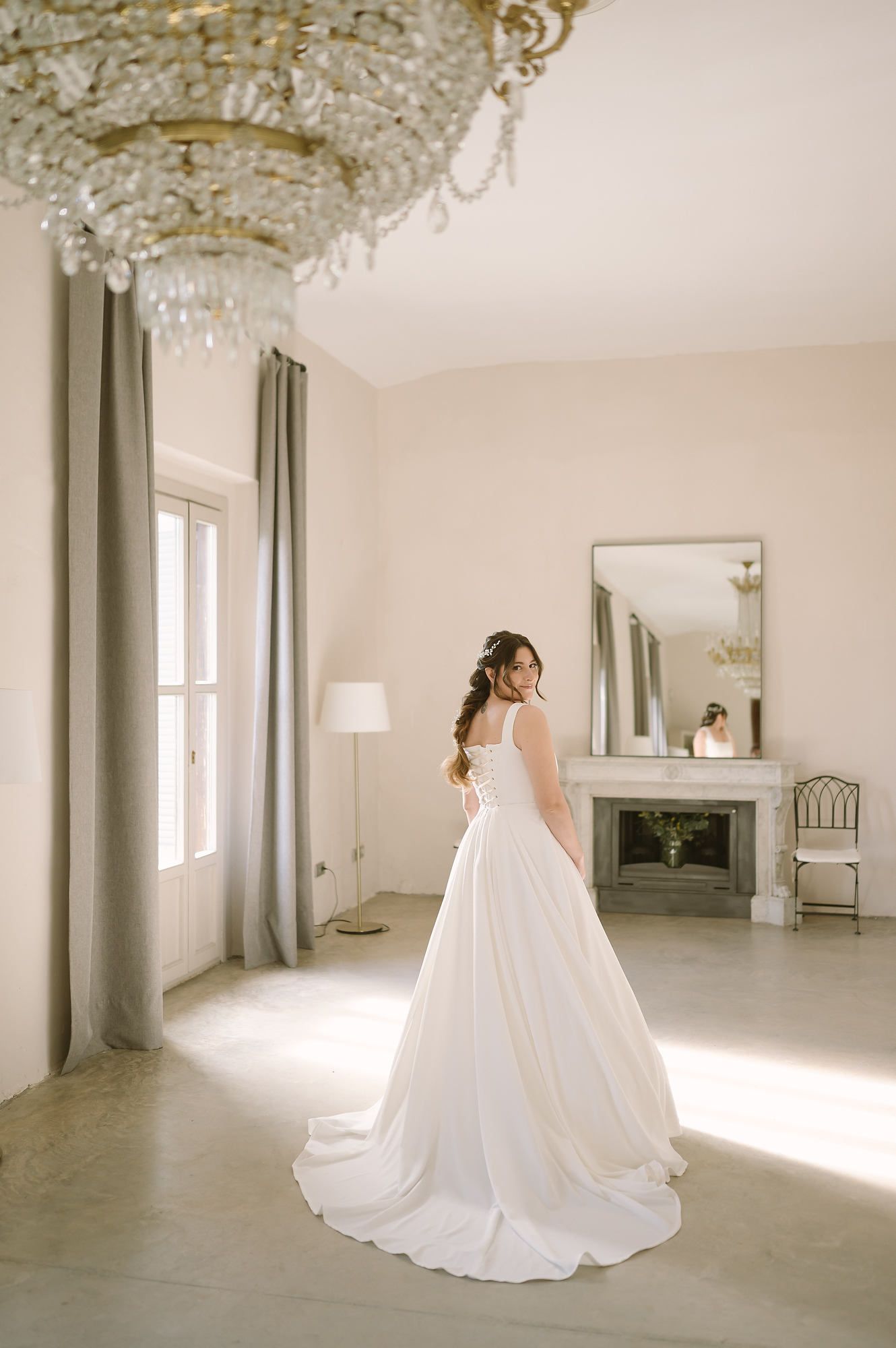 Sophisticated interior bridal shot inside the grand hall of the historic Mas d’Alzedo estate