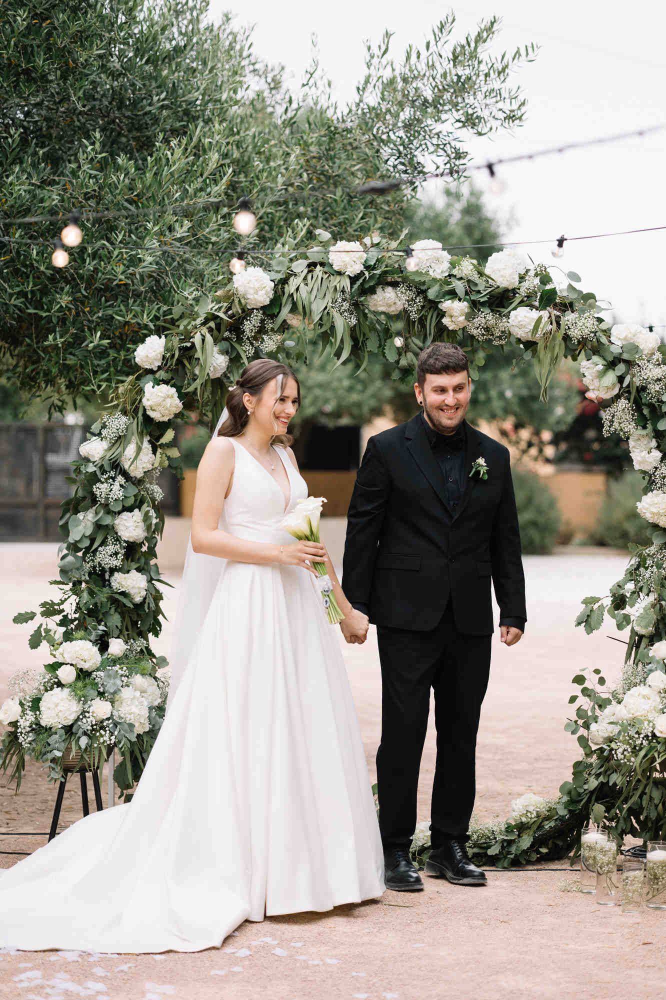 Close-up of a bride and groom sharing a joyful smile during their romantic wedding ceremony at Alqueria del Xúquer in Valencia, Spain.