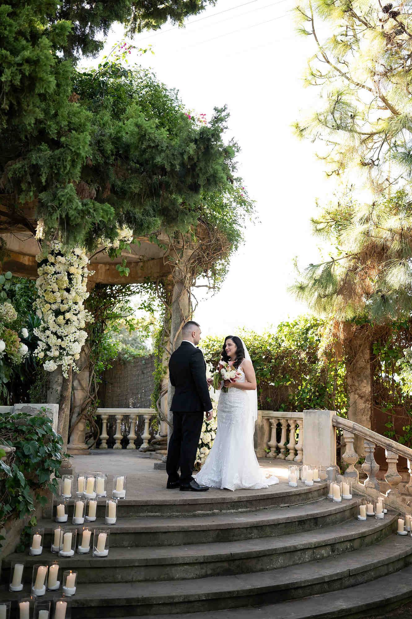 Wide shot of the couple exchanging wedding vows, capturing the historic and romantic atmosphere of the villa