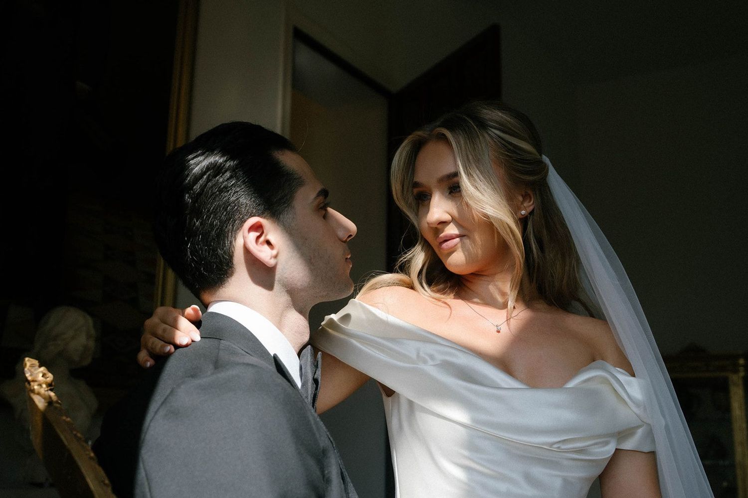 Bride and groom in a sun-drenched suite at Finca Marqués de Montemolar with makeup and hair by Anastasia Larionova in Altea.