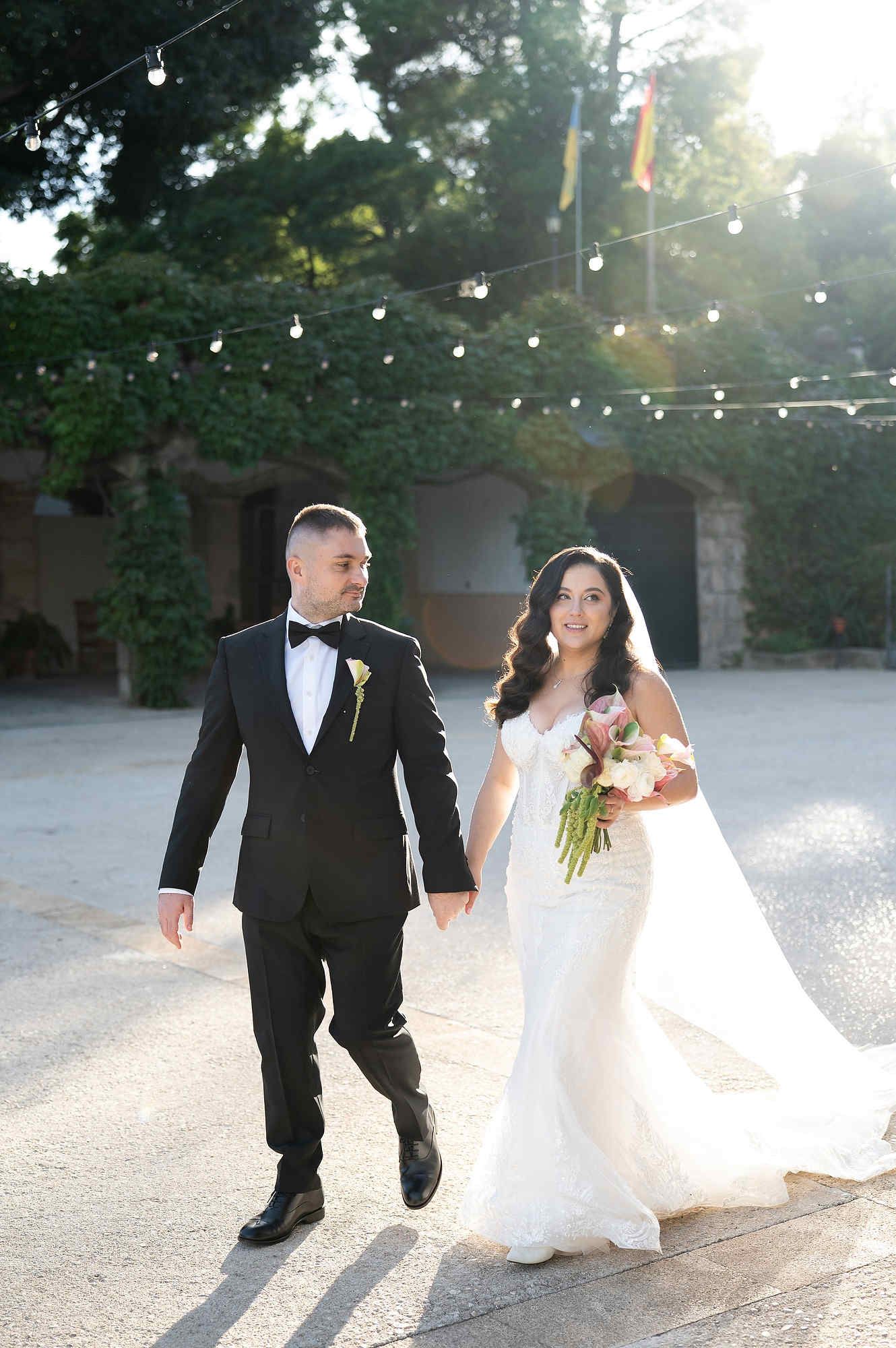 The bride and groom taking a romantic walk through the authentic stone courtyard of the Casa Santonja manor