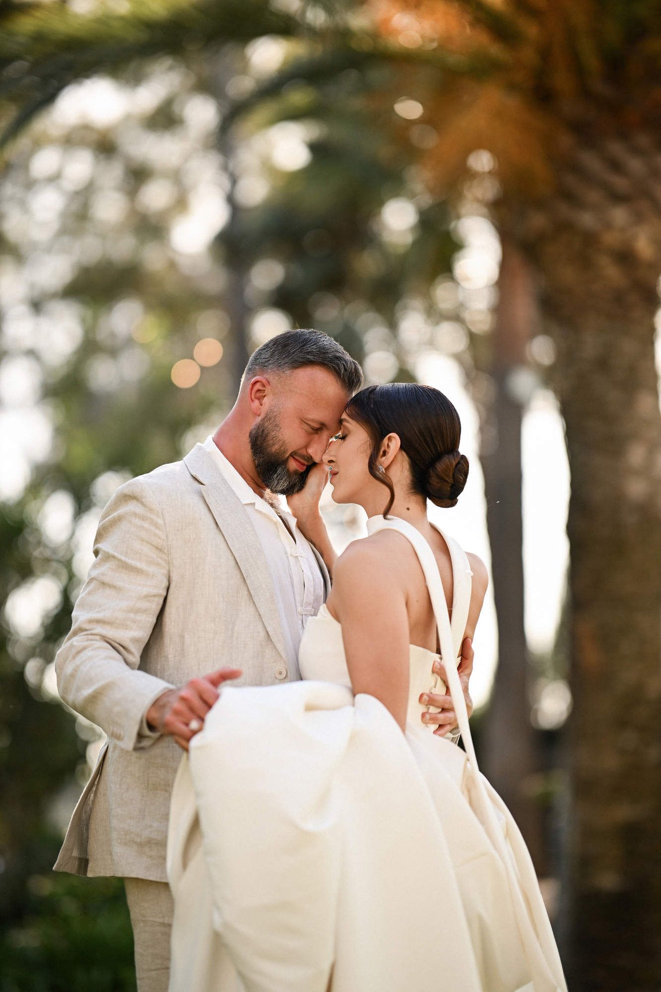 Close-up of the bride gently caressing the groom's cheek during their romantic first dance at a wedding in Villa Paula Valencia.