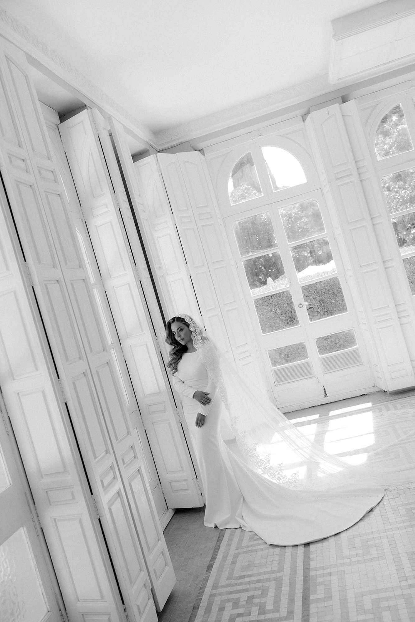 Full-length portrait of a bride inside Finca Torrefiel with a long veil and dress train. Luxury bridal inspiration in Spain.