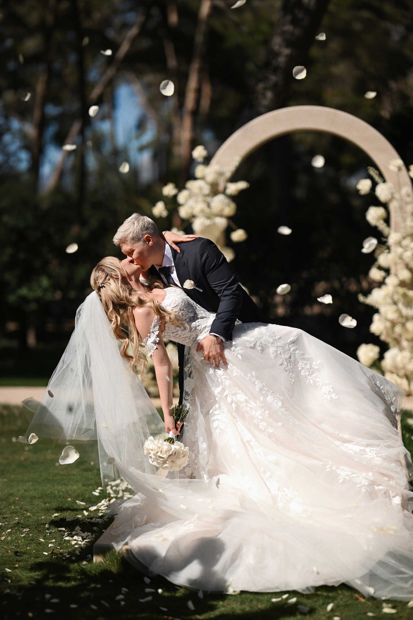 Groom dips the bride at Alicante wedding. Her Hollywood waves hairstyle stays perfect under the hot sun at Finca El Senoret